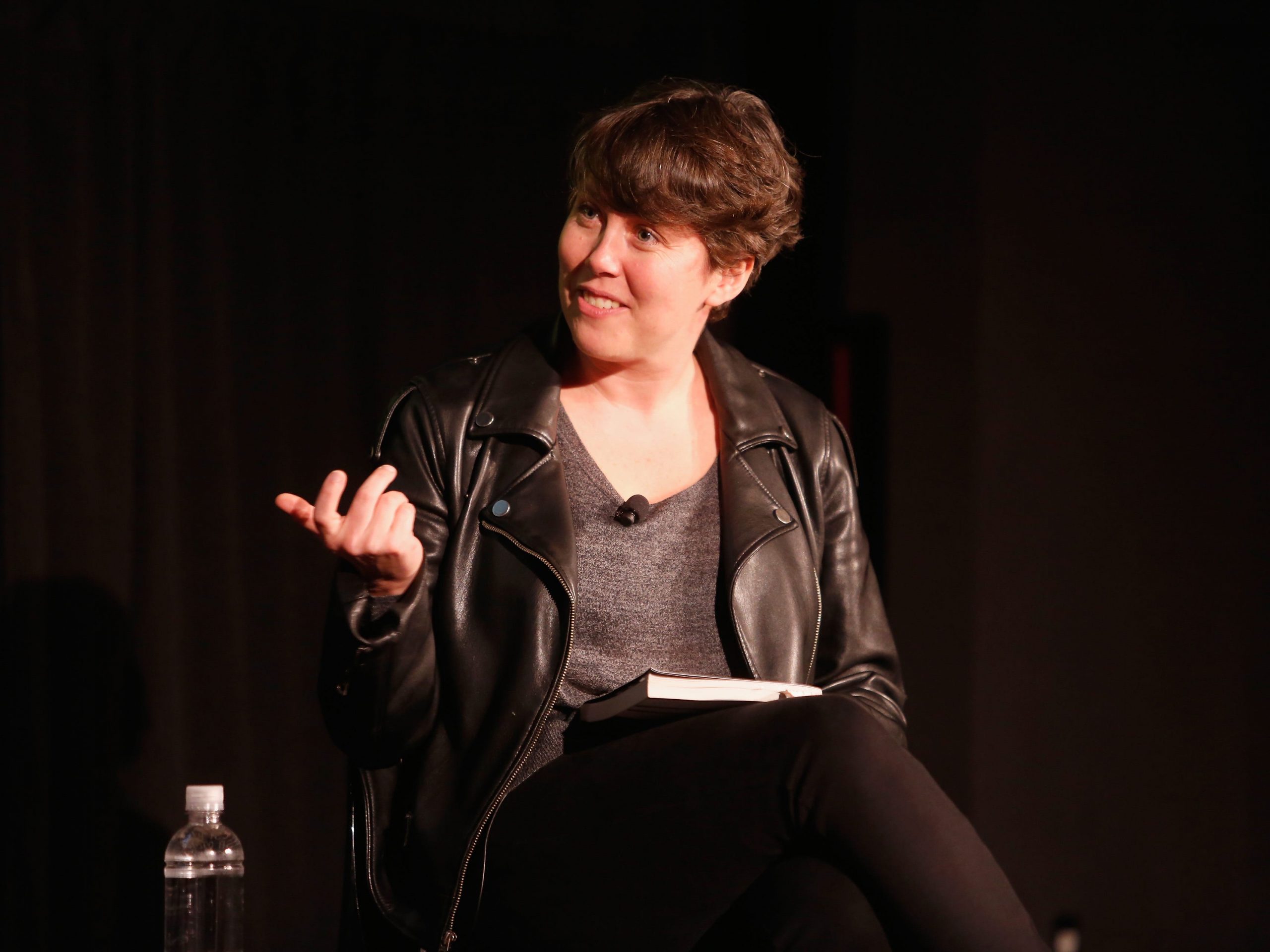 Kristen Roupenian sitting on stage, looking slightly to the right and gesturing