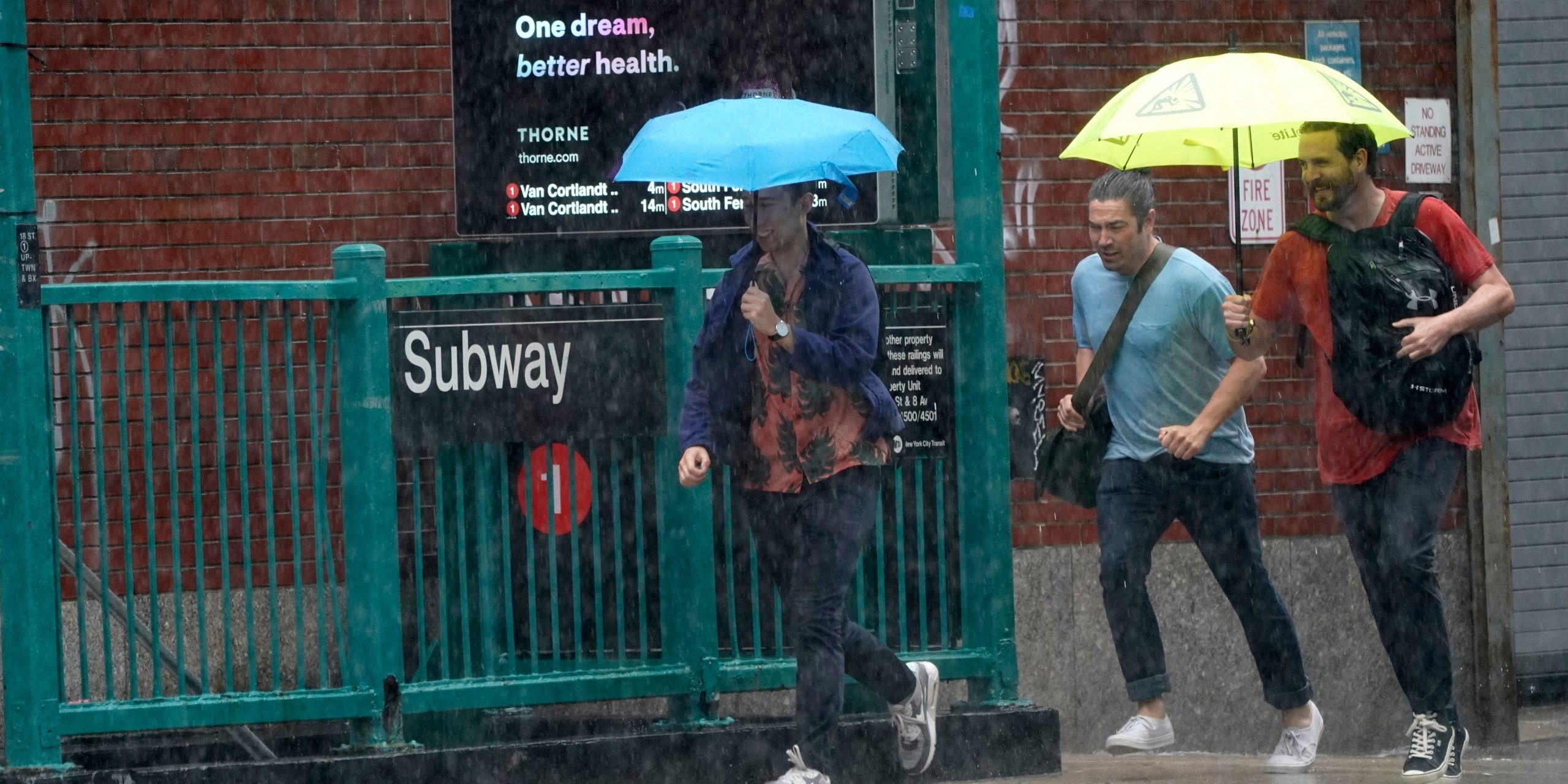 People run in the rain outside a subway station in New York City.