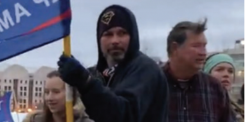 Michael Perkins holding a Trump flag.