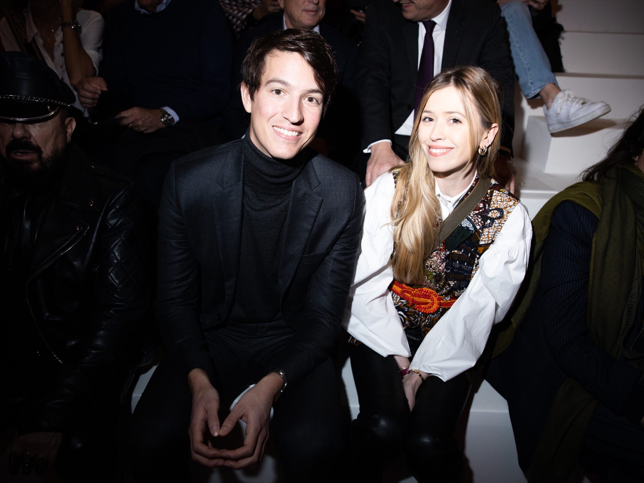 alexandre arnault and fiancee geraldien sit at a fashion show in paris