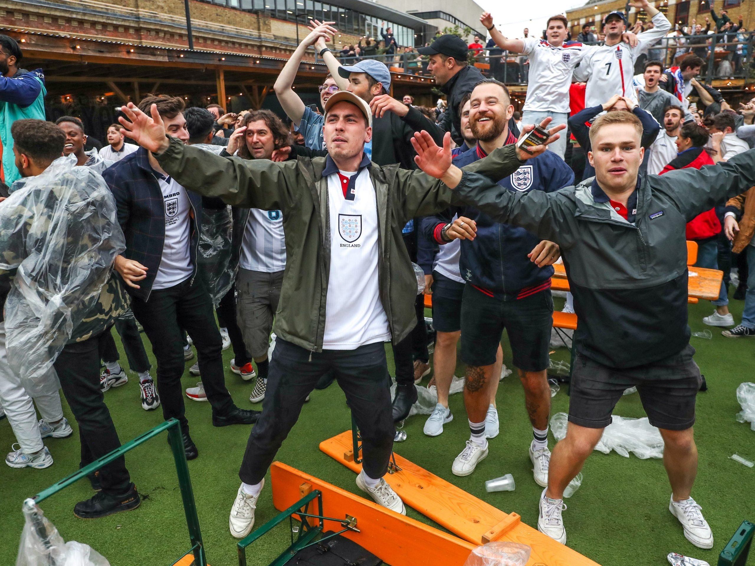 Fans celebrate during the UEFA Euro 2020 round of 16 match between England and Germany at the Vinegar Yard pub in London, June 29, 2021.