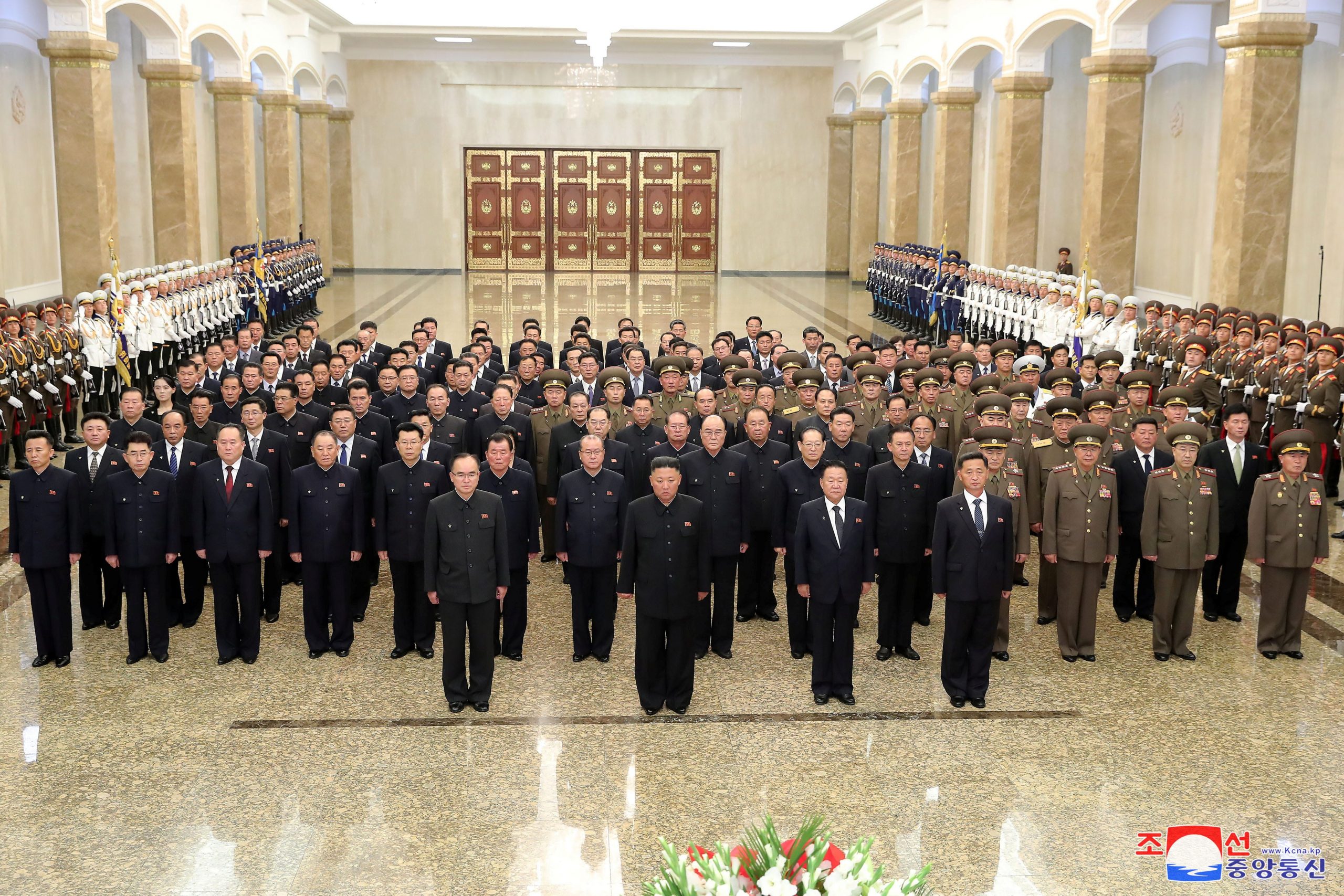 North Korean leader Kim Jong Un poses with dozens of senior leaders at a palace