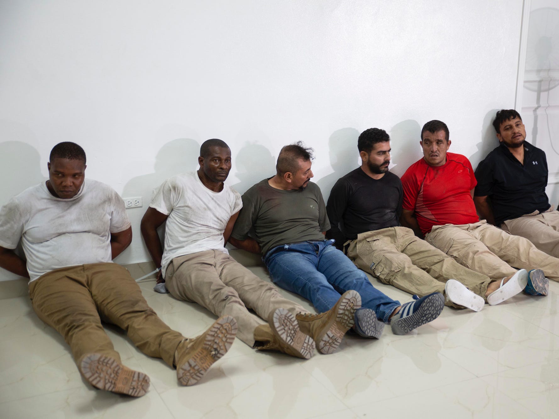 James Solages sits on the floor alongside five other suspects in the killing of Haitian president Jovenel Moïse.