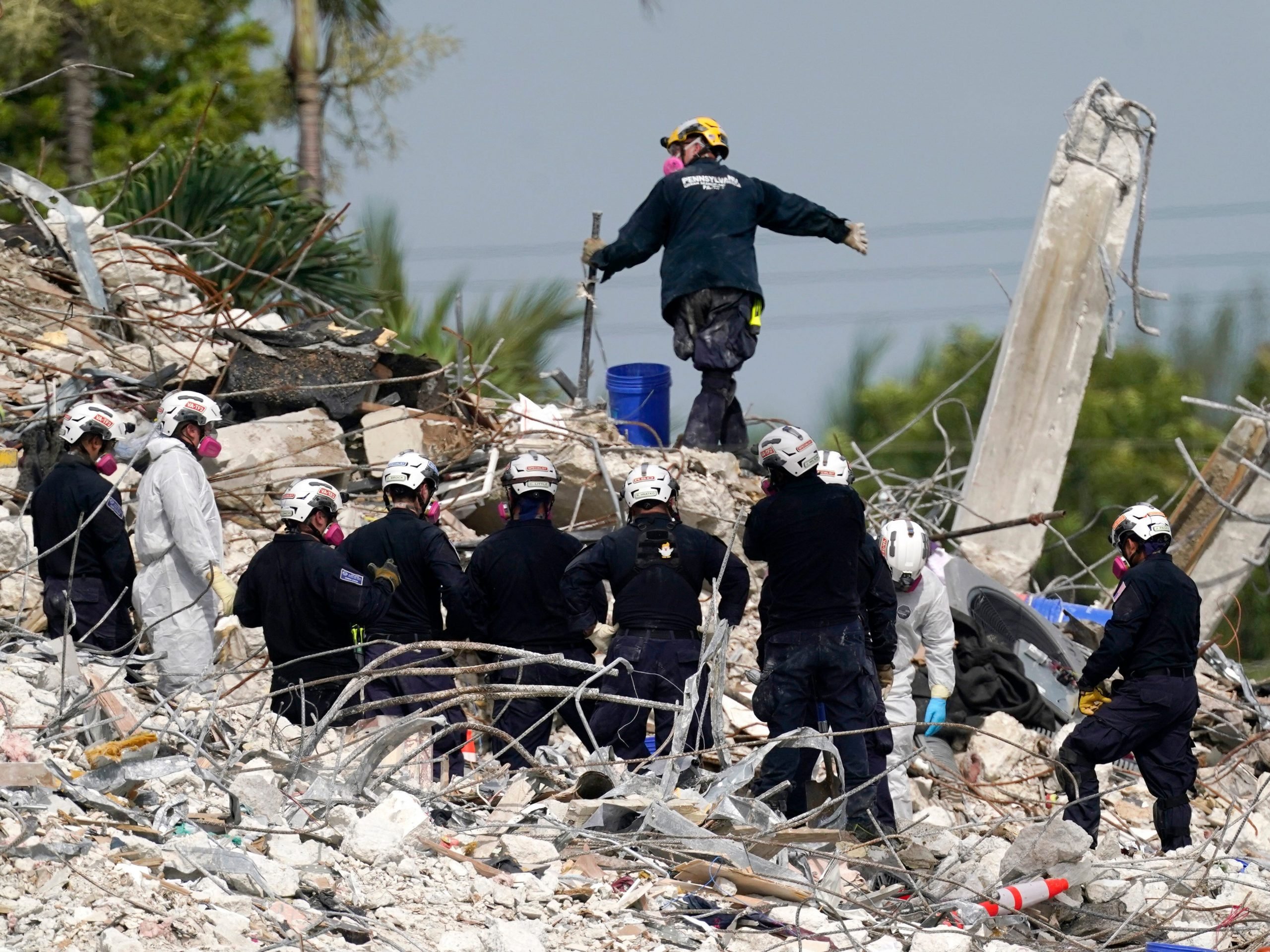 Rescue crews work at the site of the collapsed Champlain Towers South condo building after the remaining structure was demolished Sunday