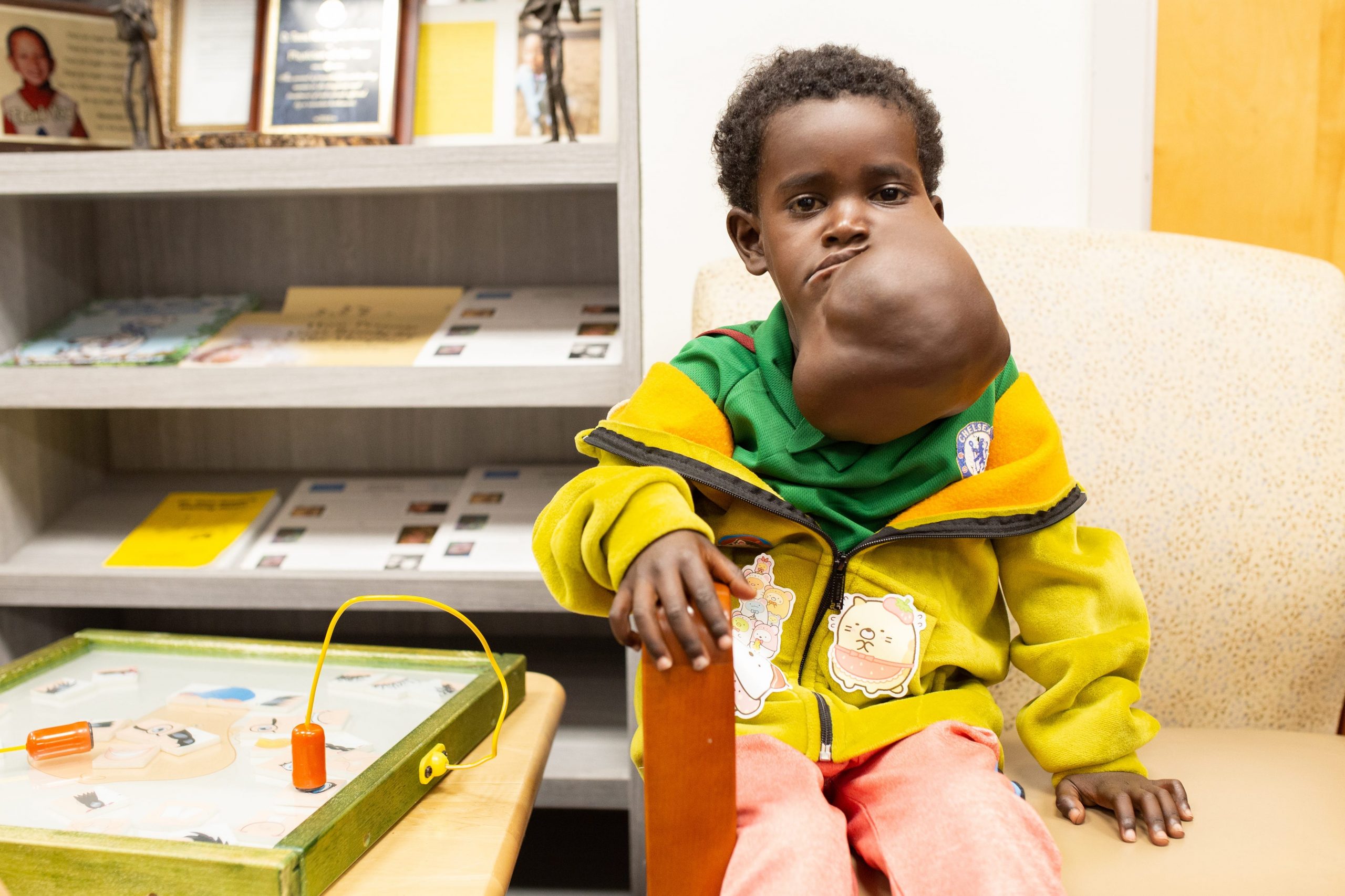 Negalem sits in a waiting room during a pre-surgery consultation.