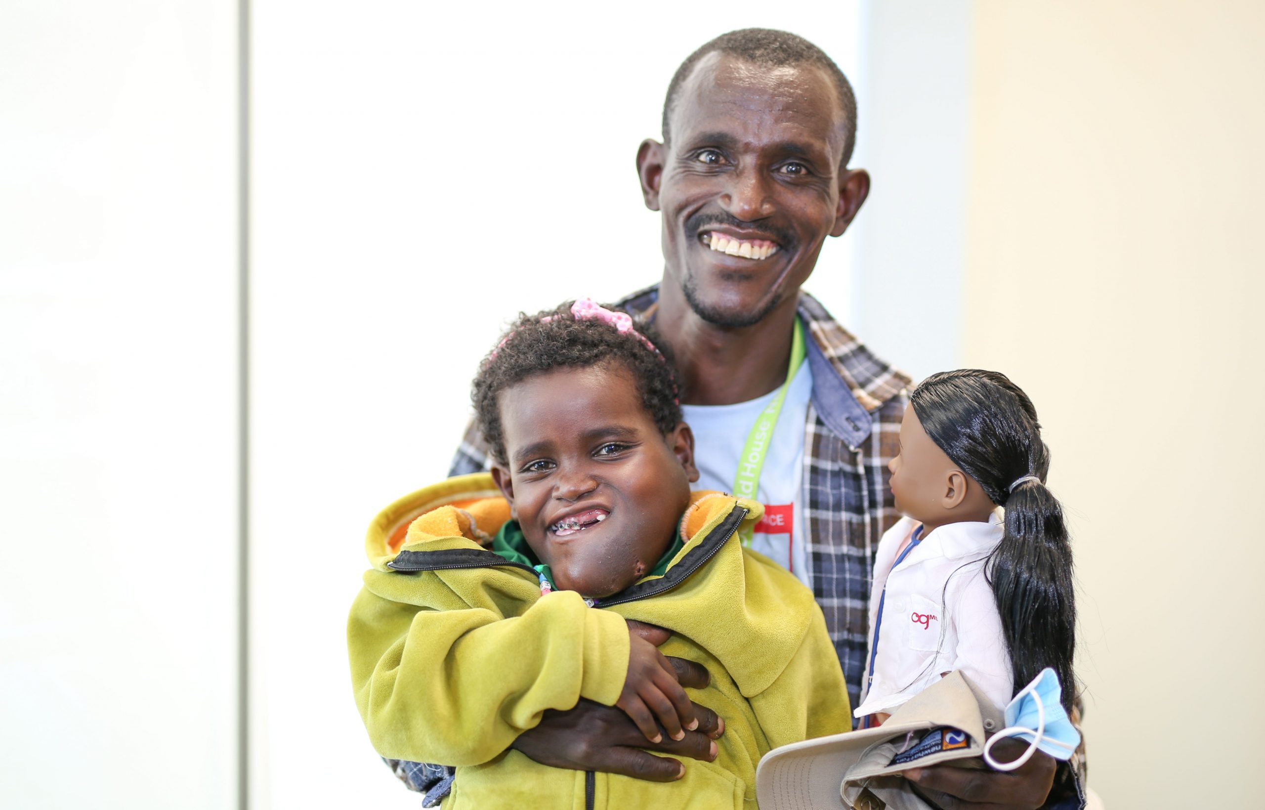 Negalem and her father with a doll dressed as a doctor.