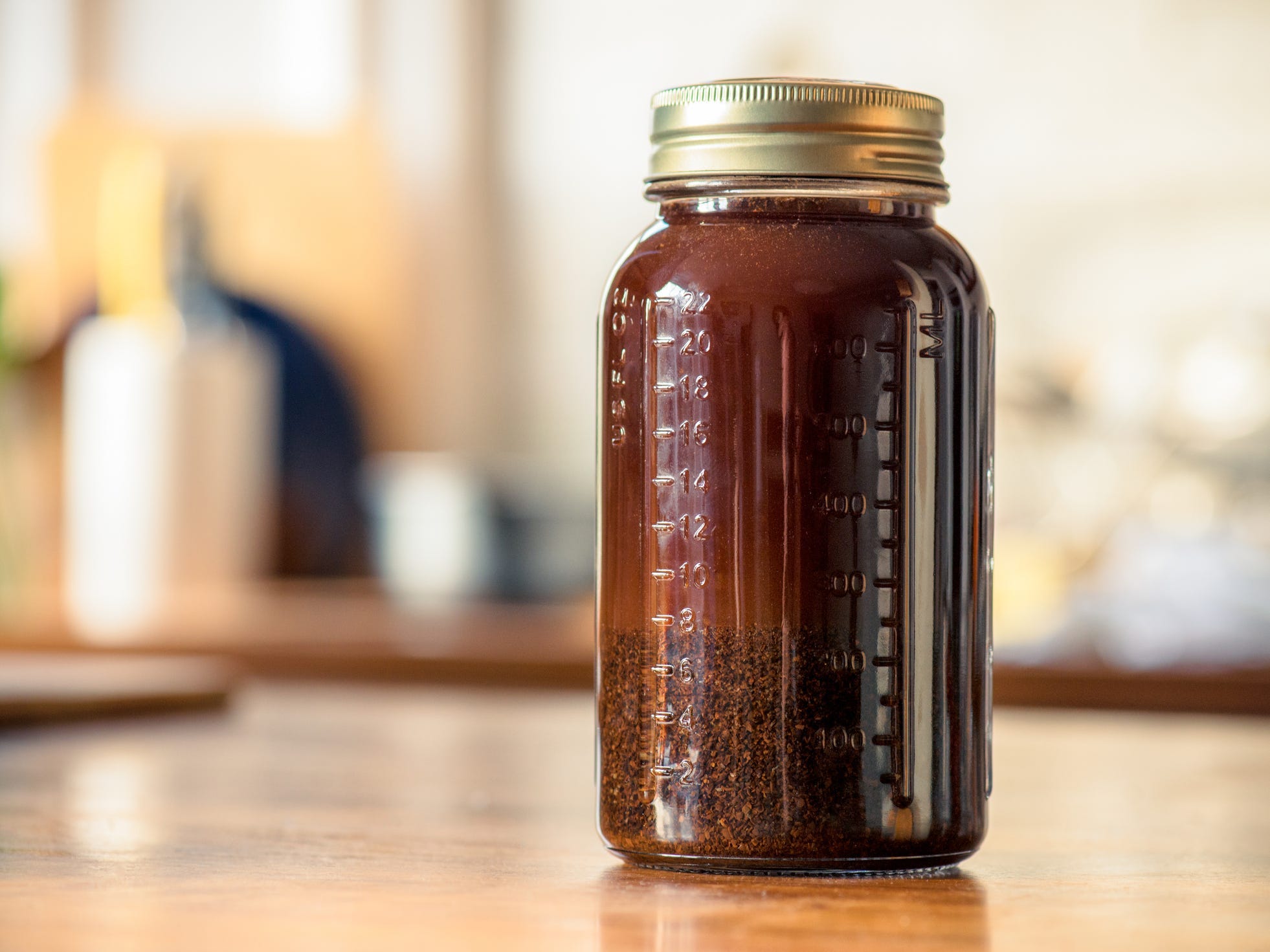 A large mason jar full of coffee grounds and water