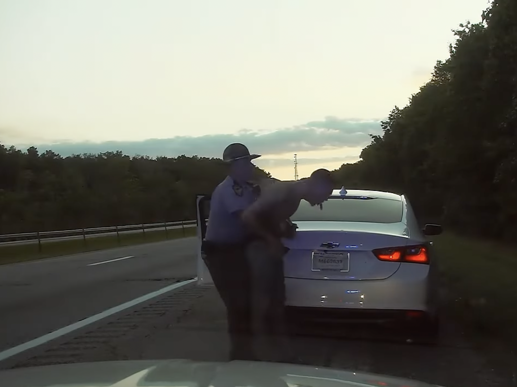 Screengrab of video of man being performed Heimlich remover on by state trooper after swallowing a bag of weed