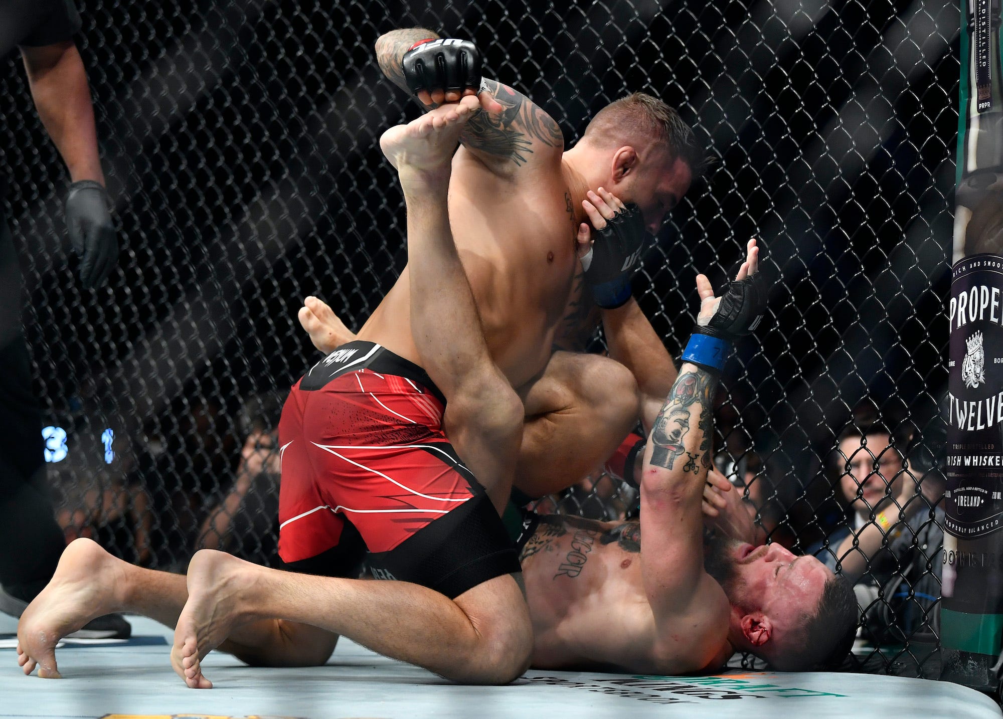 Dustin Poirier hits Conor McGregor during ground-and-pound exchanges.