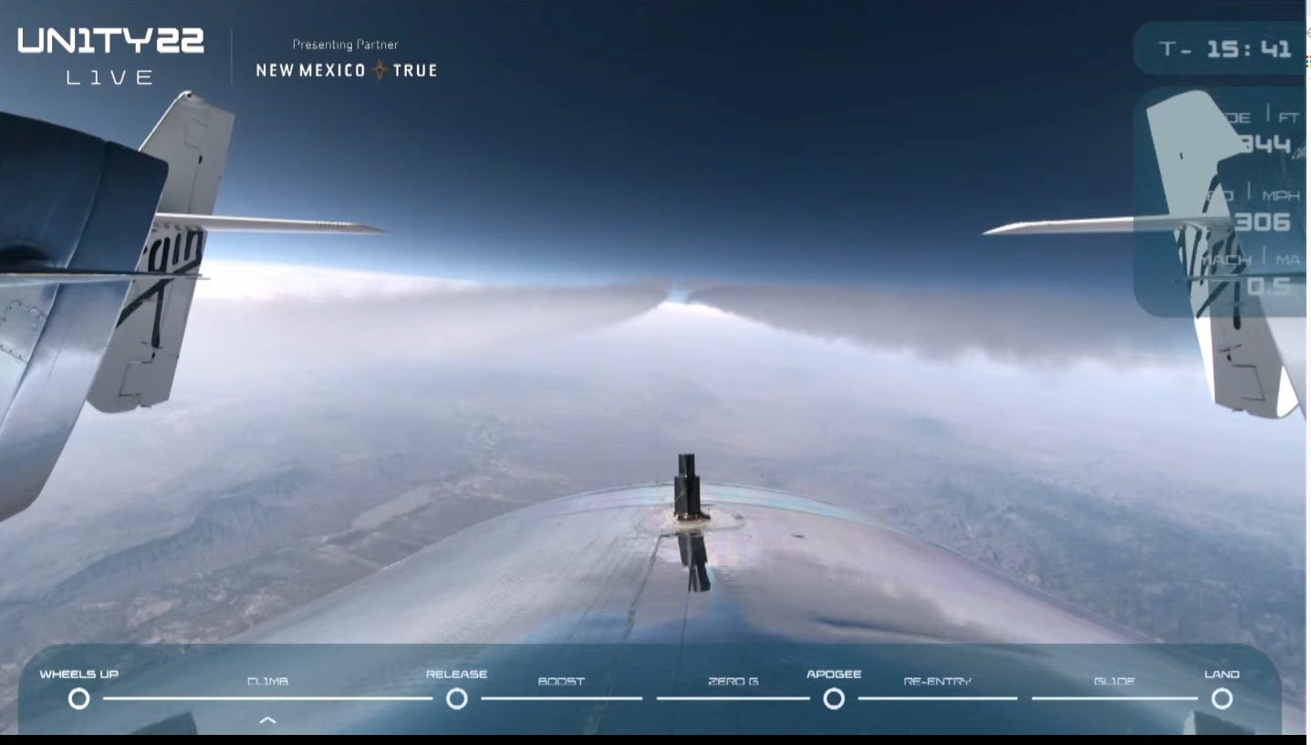 virgin galactic space plane spaceshiptwo aboard vms eve mothership flying through the sky contrails streaming behind