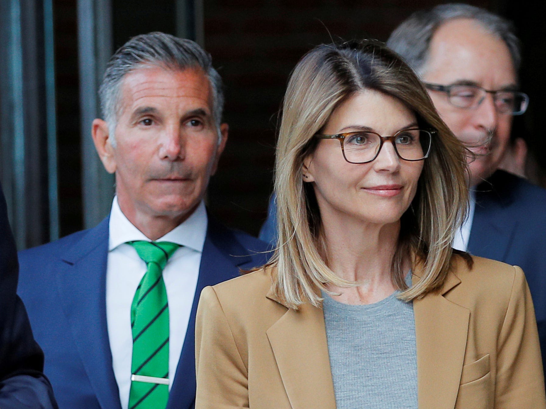 FILE PHOTO: Actor Lori Loughlin, and her husband, fashion designer Mossimo Giannulli, leave the federal courthouse after facing charges in a nationwide college admissions cheating scheme, in Boston, Massachusetts, U.S., April 3, 2019. REUTERS/Brian Snyder/File Photo