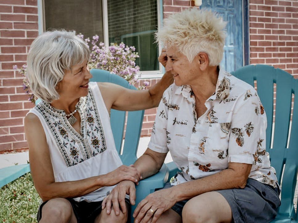 Two married women sit next to each other.