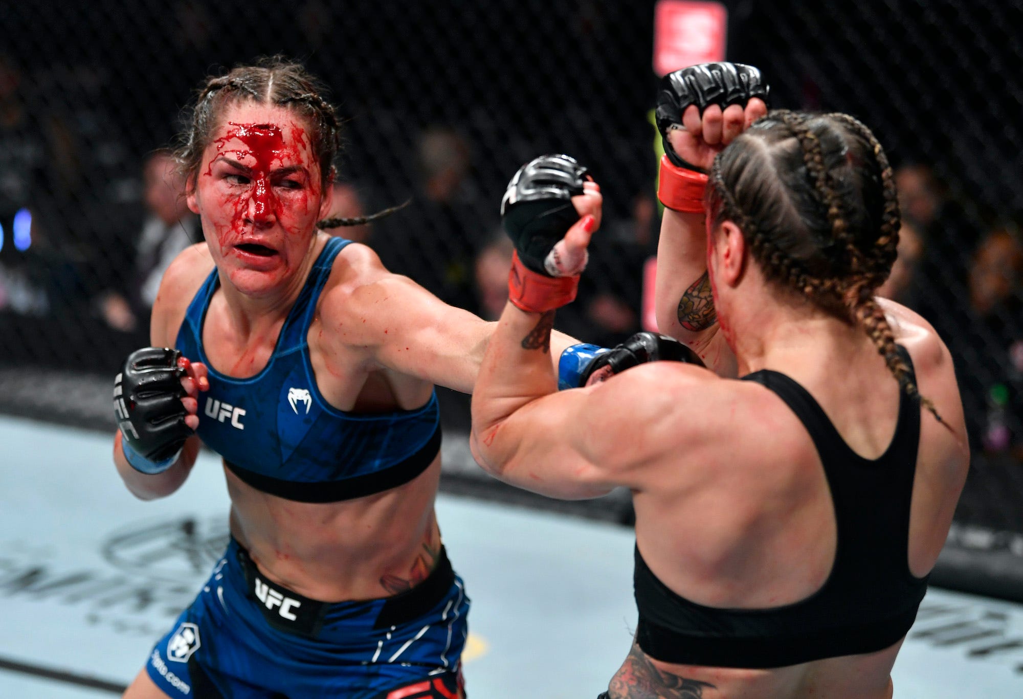 Jessica Eye fights through a horrible cut that bleeds all over her face.