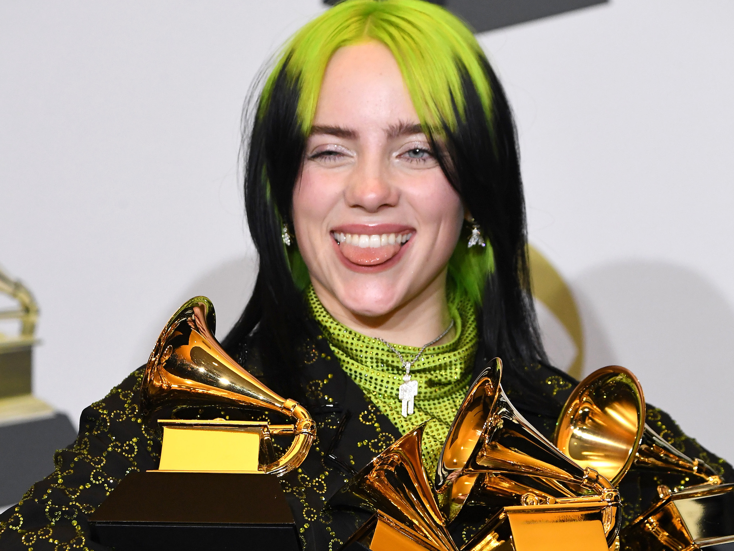 billie eilish holding four grammy awards