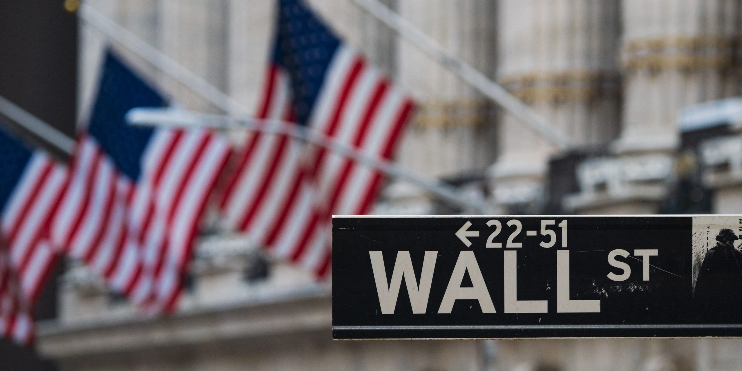 A Wall St sign hangs at the New York Stock Exchange (NYSE) at Wall Street on March 23, 2021 in New York City.