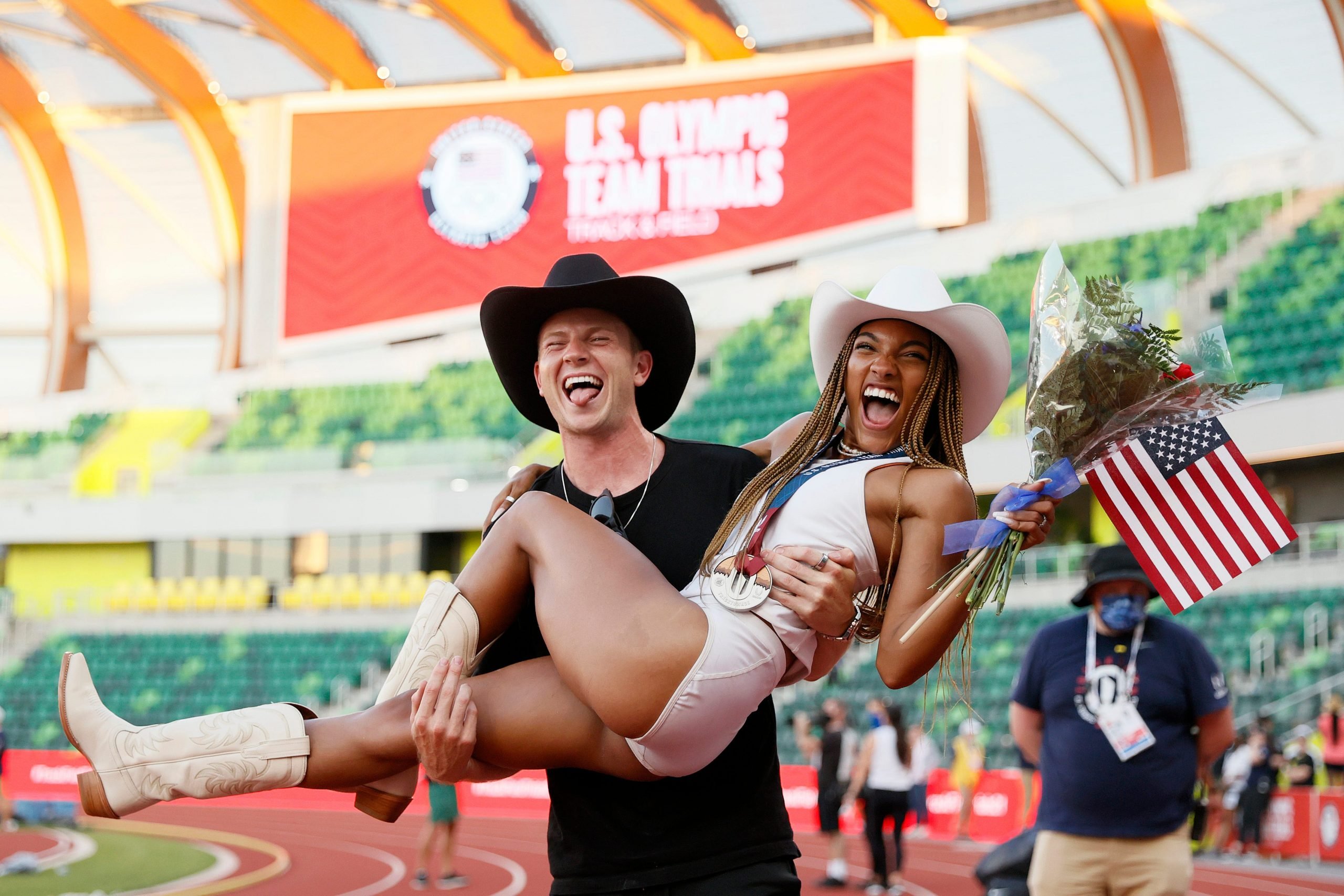 Hunter Woodhall holds Tara Davis in his arms