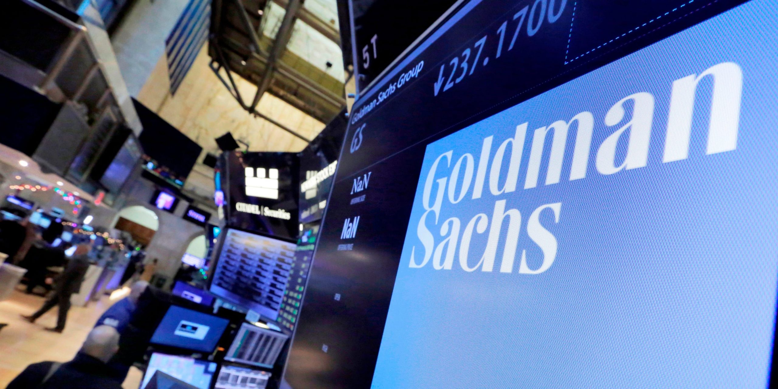 In this Dec. 13, 2016, file photo, the logo for Goldman Sachs appears above a trading post on the floor of the New York Stock Exchange. Goldman Sachs said its profits more than doubled from a year earlier thanks to a surge in both trading and advising revenue.