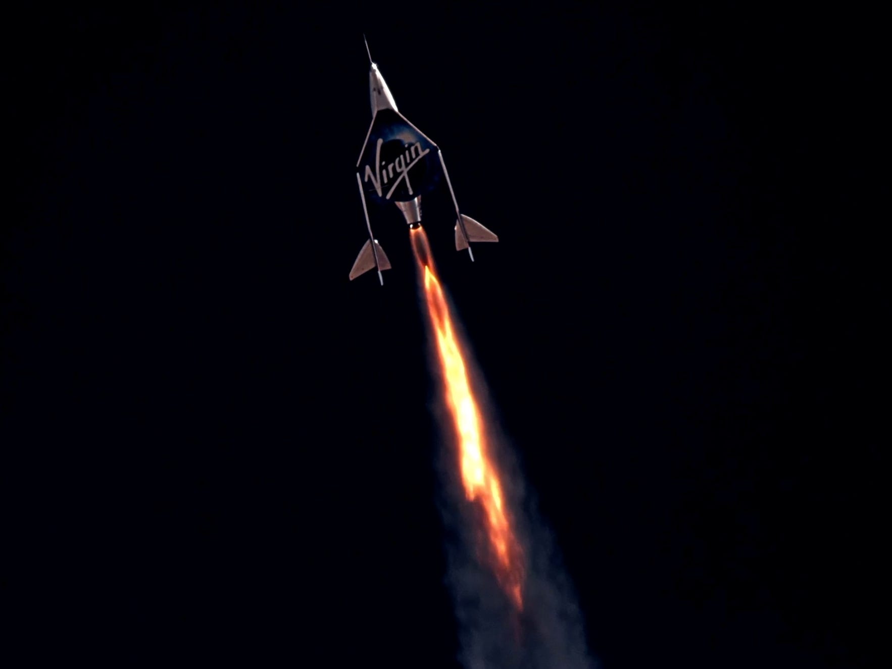 virgin galactic space plane firing engines flying up