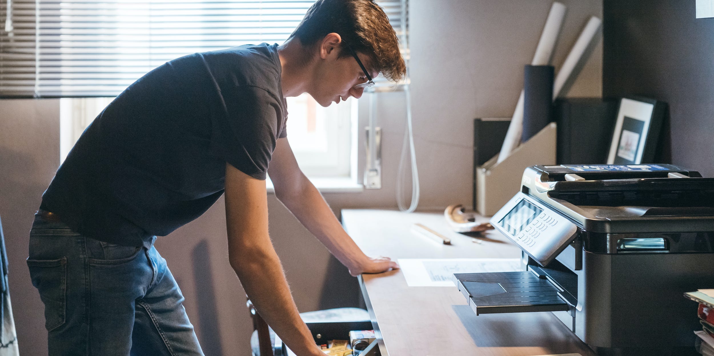 Person using printer at home to print documents