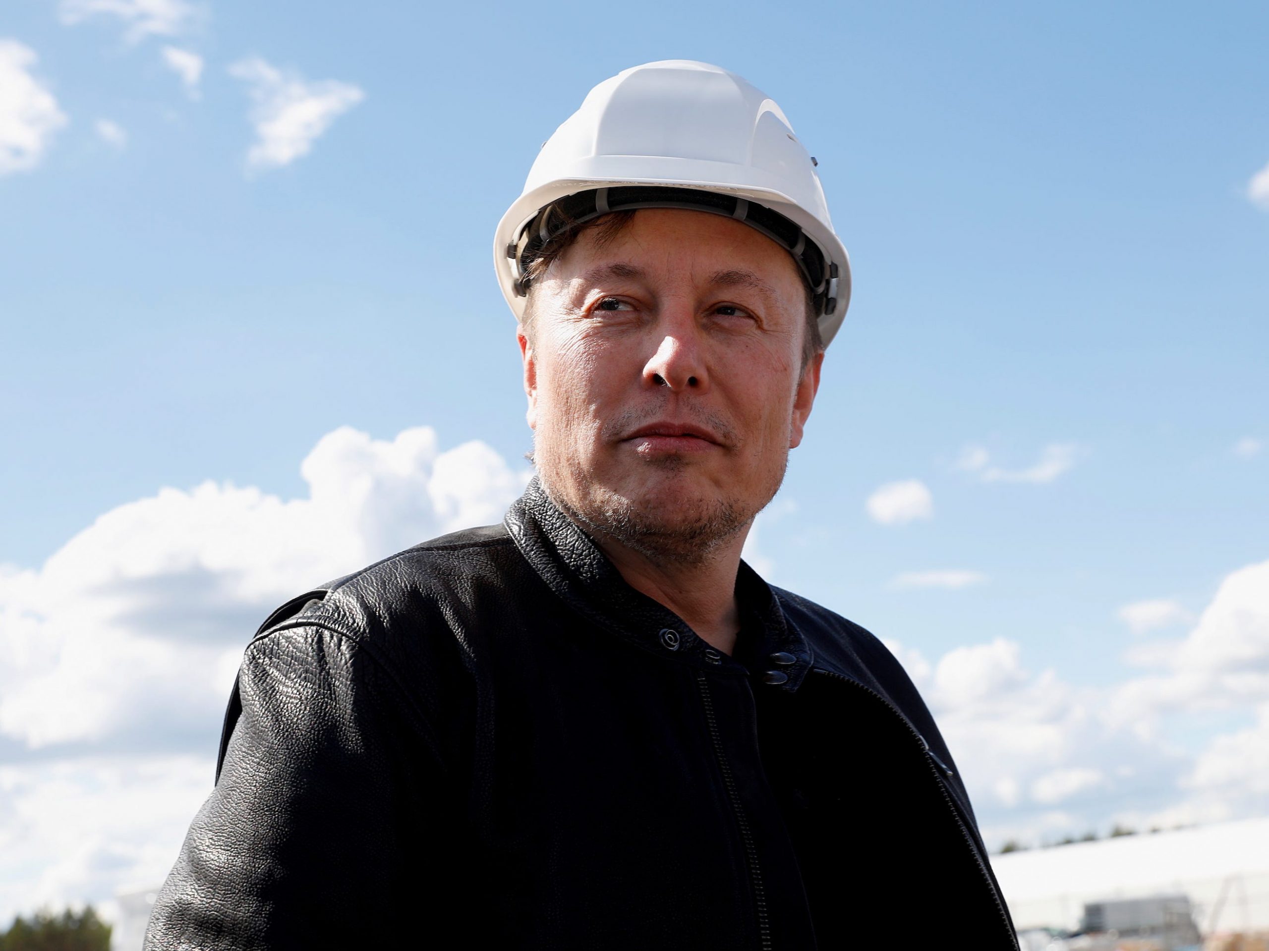 Tesla CEO Elon Musk wearing a construction helmet.