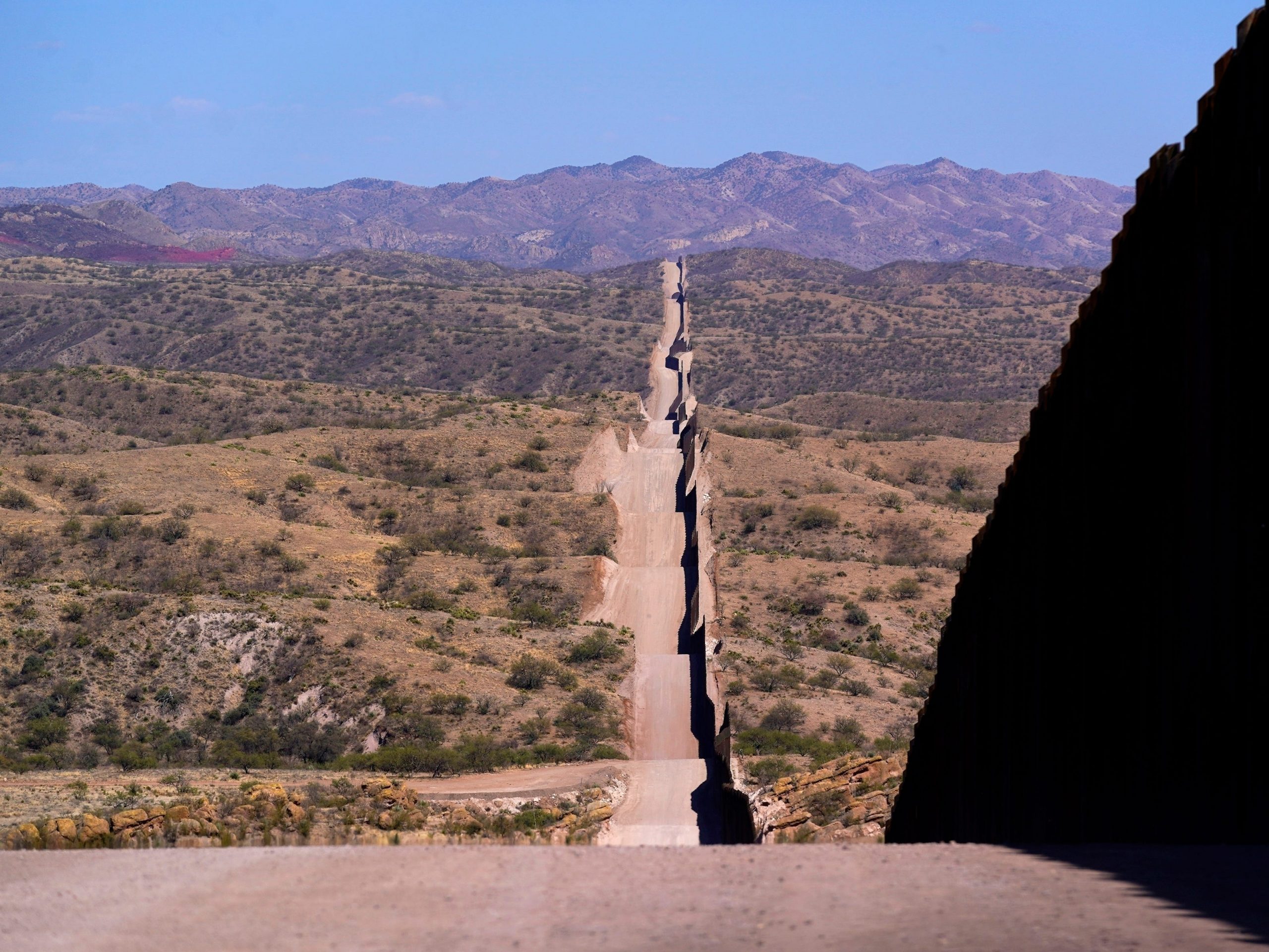 In this May 19, 2021 file photo the border wall stretches along the landscape near Sasabe, Ariz.