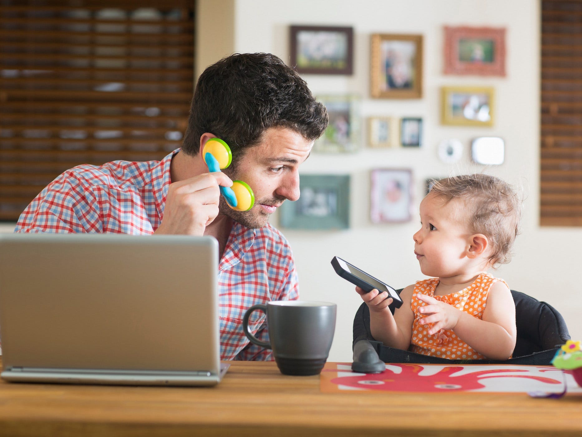 dad and baby on cellphones at home