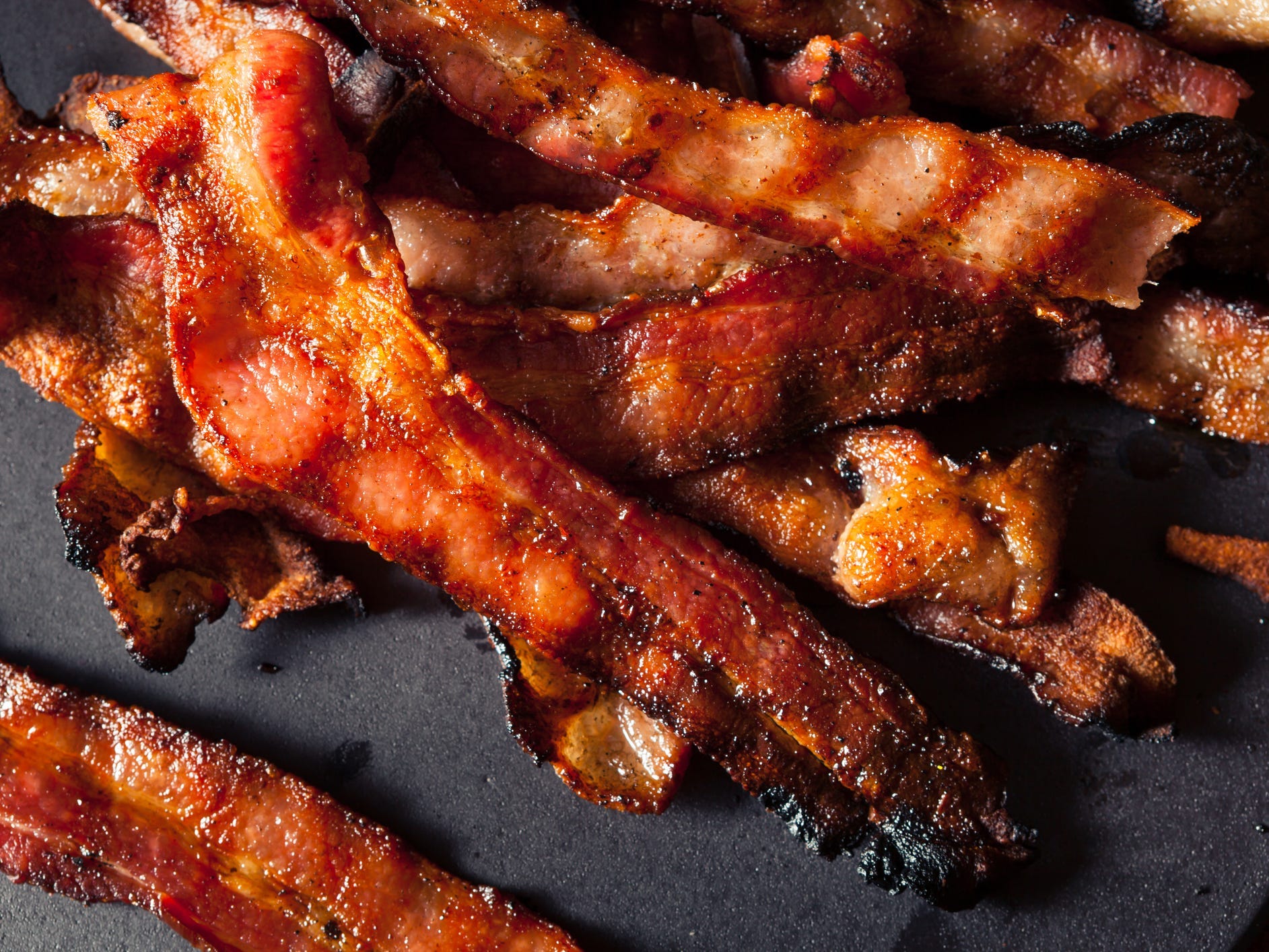 A pile of bacon on a dark background