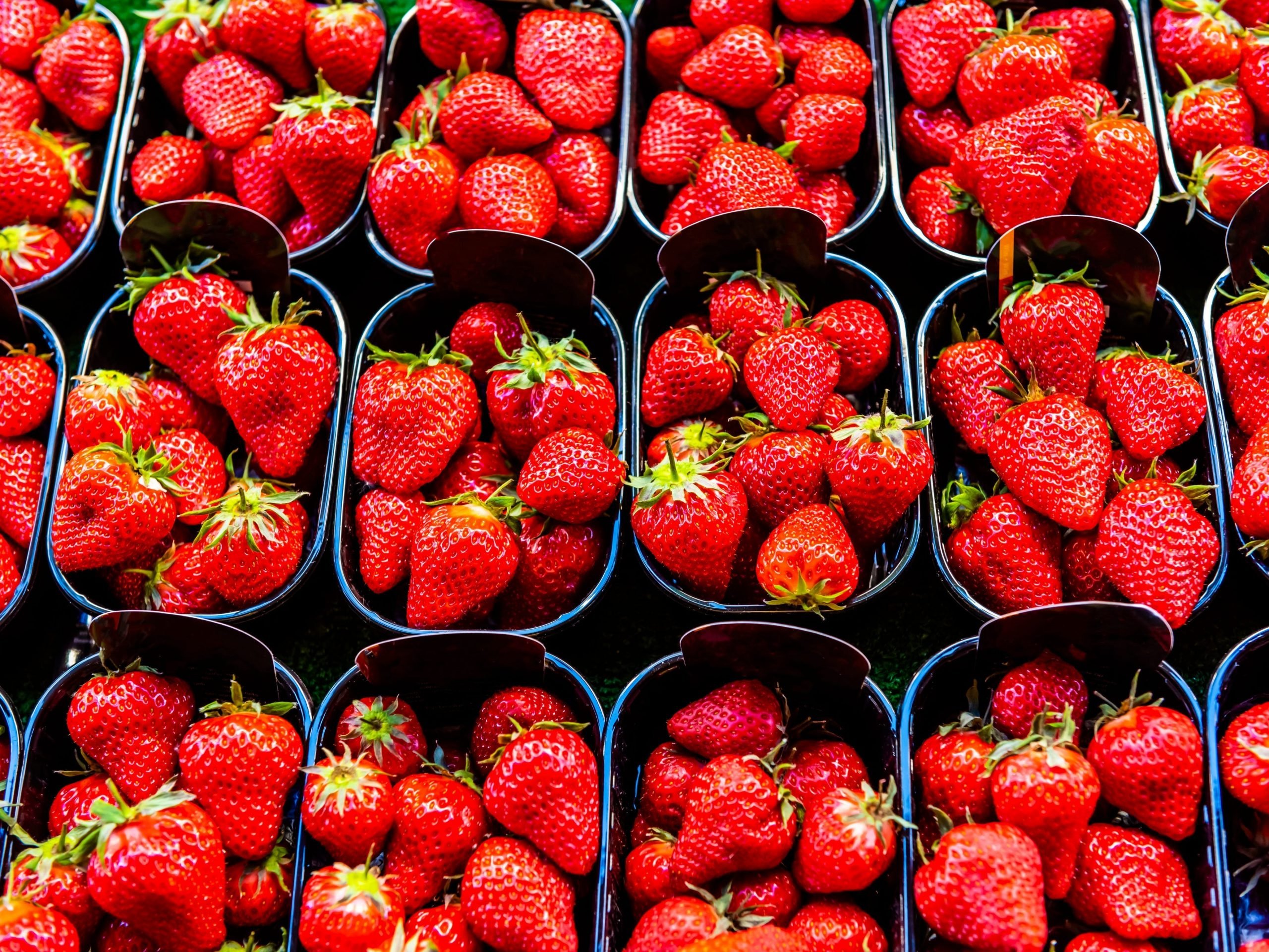 Strawberries for sale at Rue Cler street market, Paris, France.