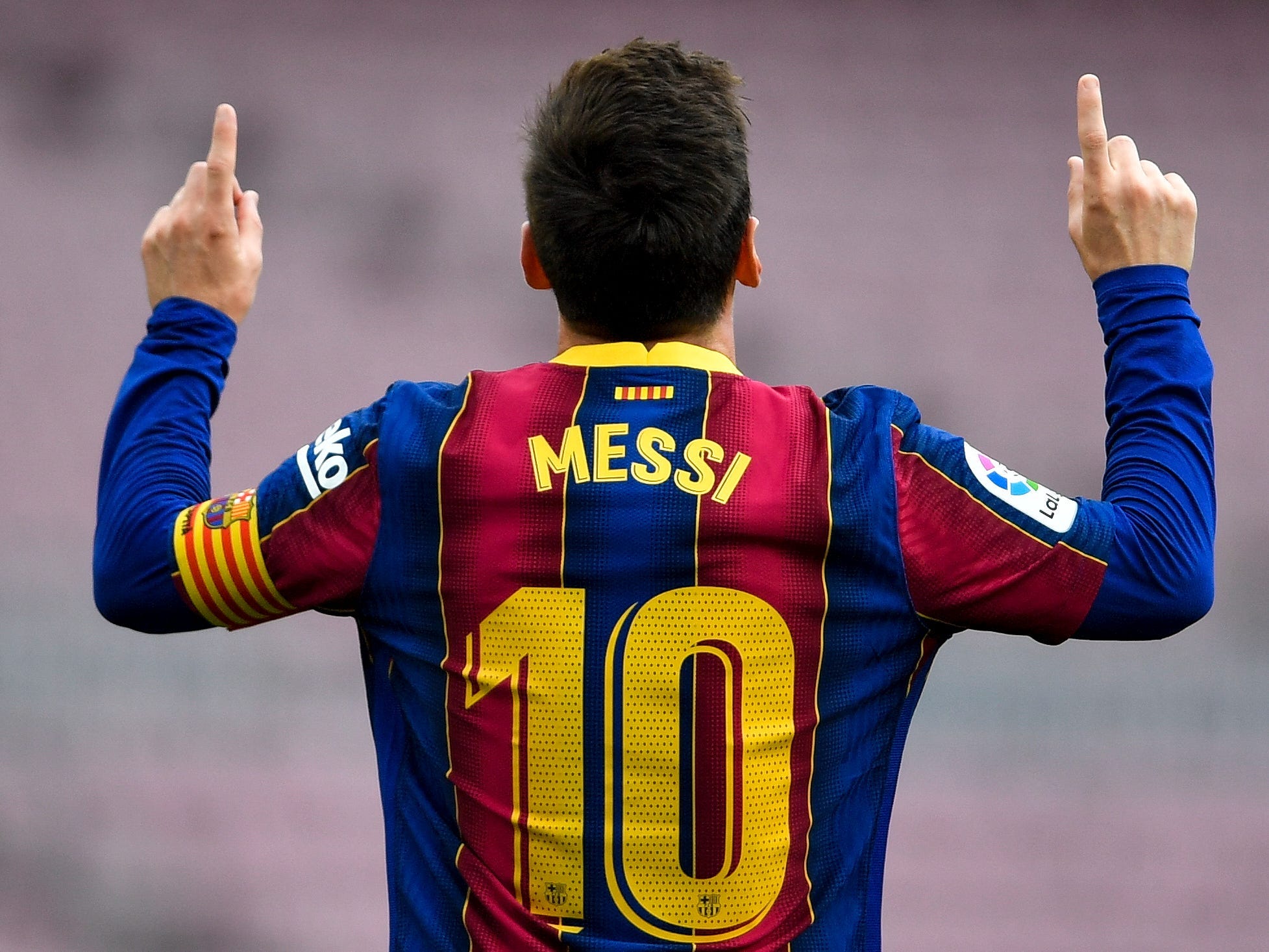 Barcelona's Lionel Messi raises two fingers in celebration