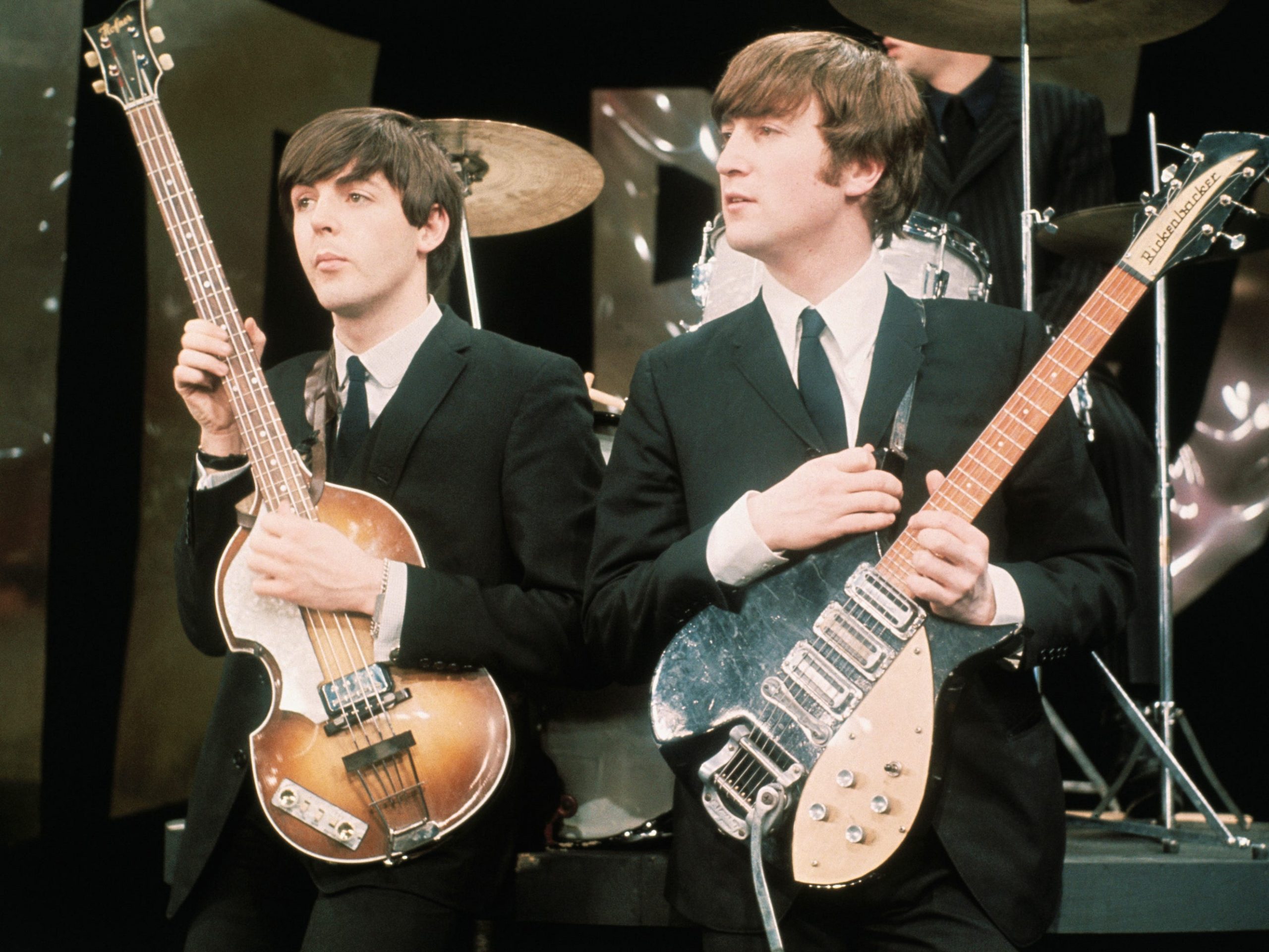 paul mccartney john lennon holding guitars onstage