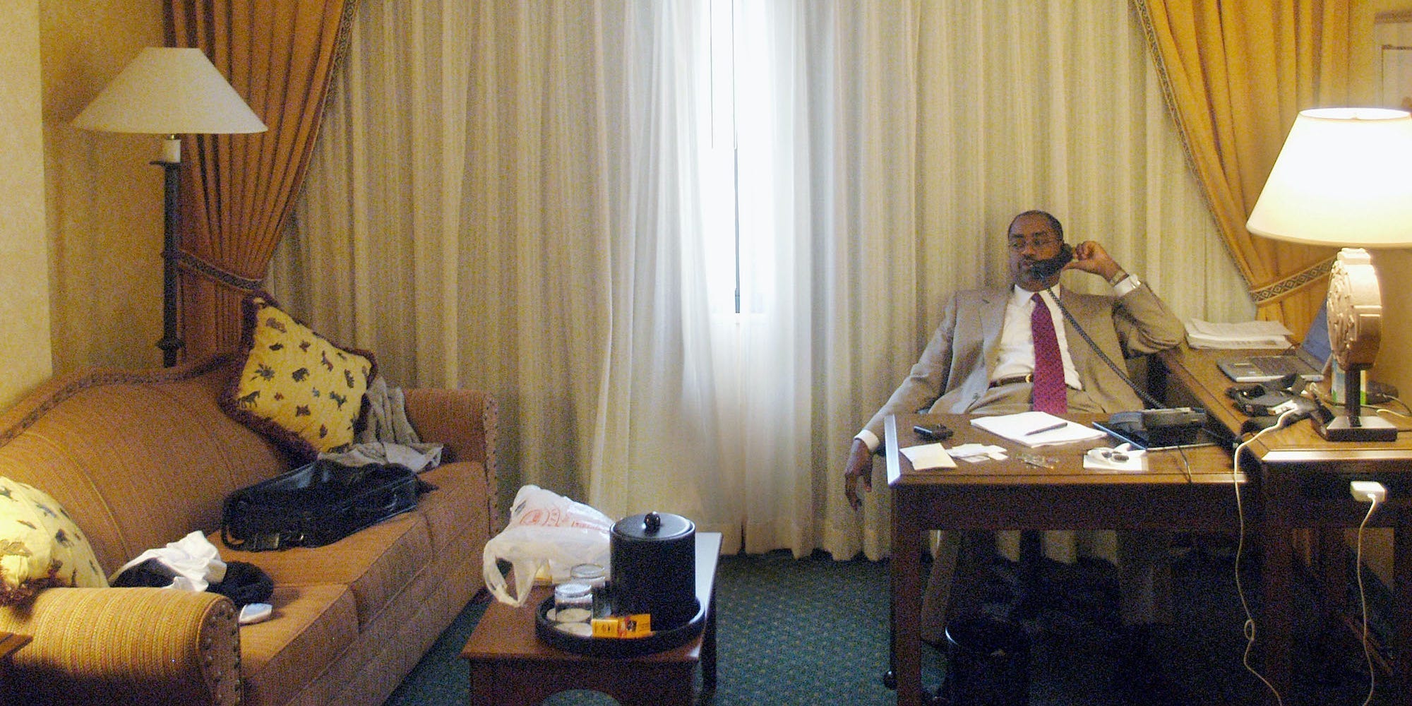 Texas state Senator Rodney Ellis talks with his wife by phone during the third day of his stay with other Democratic senators in the Marriot Hotel July 30, 2003 in Albuquerque, New Mexico.