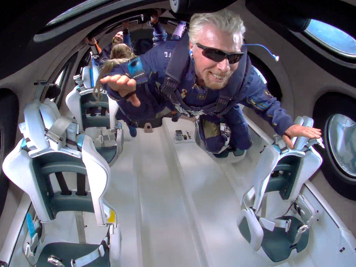 Richard Branson and his crewmates flying in zero gravity in Virgin Galactic's spacecraft