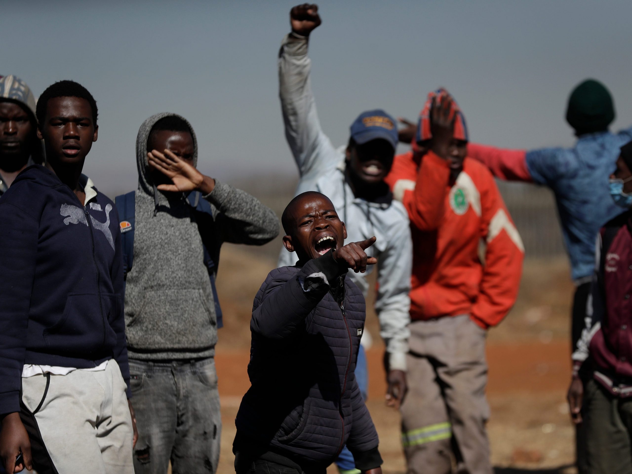 A group of men shout as they try to enter a shopping mall in Vosloorus, east of Johannesburg, South Africa on July 14.