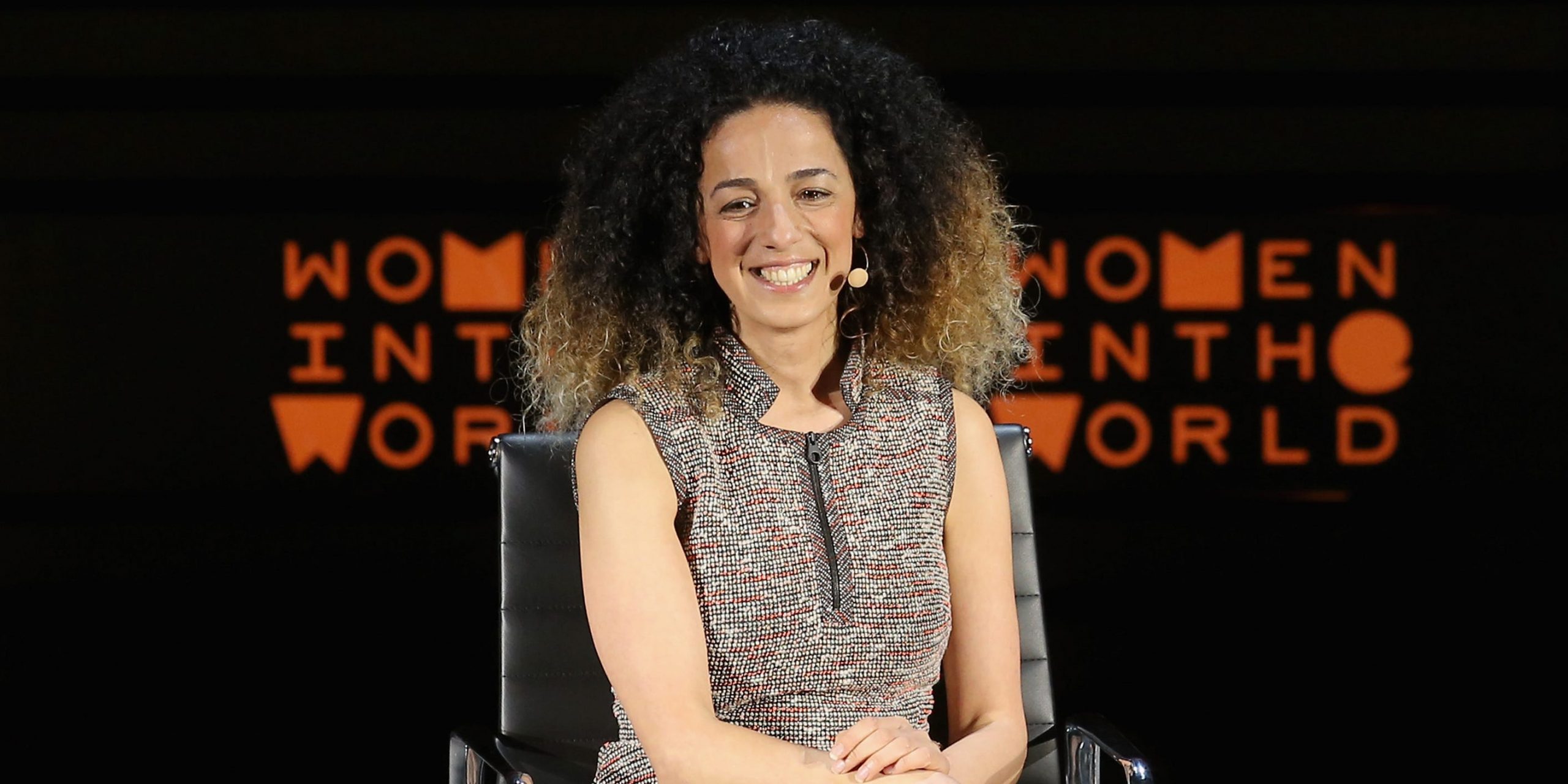Masih Alinejad sits onstage.