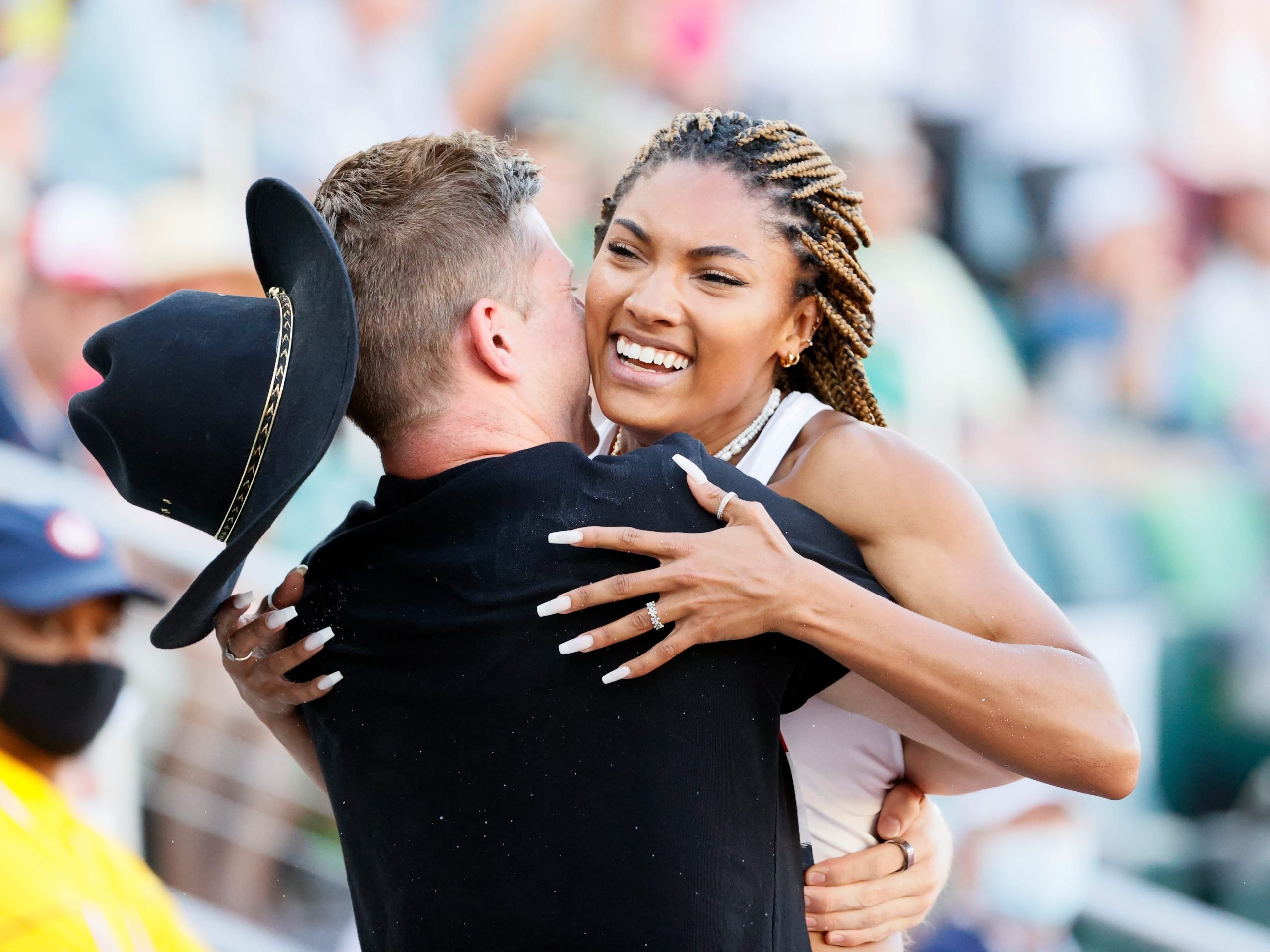 Paralympian Hunter Woodhall embraces his girlfriend, first-time Olympian Tara Davis, after she qualifies in track & field.