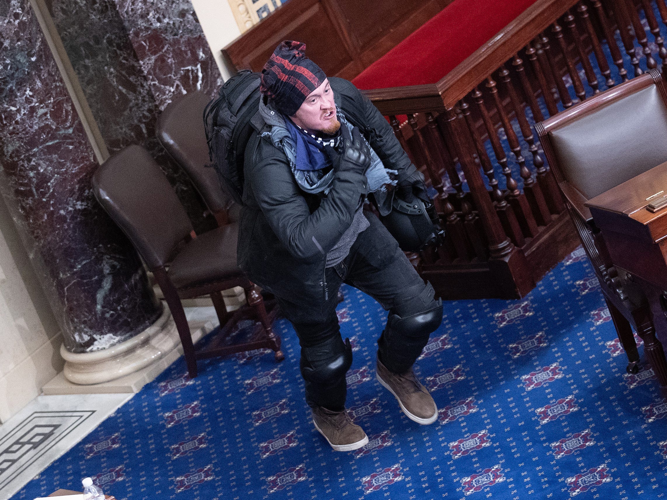 A protester supporting U.S. President Donald Trump moves to the floor of the Senate chamber at the U.S. Capitol Building on January 06, 2021 in Washington, DC. Congress held a joint session today to ratify President-elect Joe Biden's 306-232 Electoral College win over President Donald Trump.
