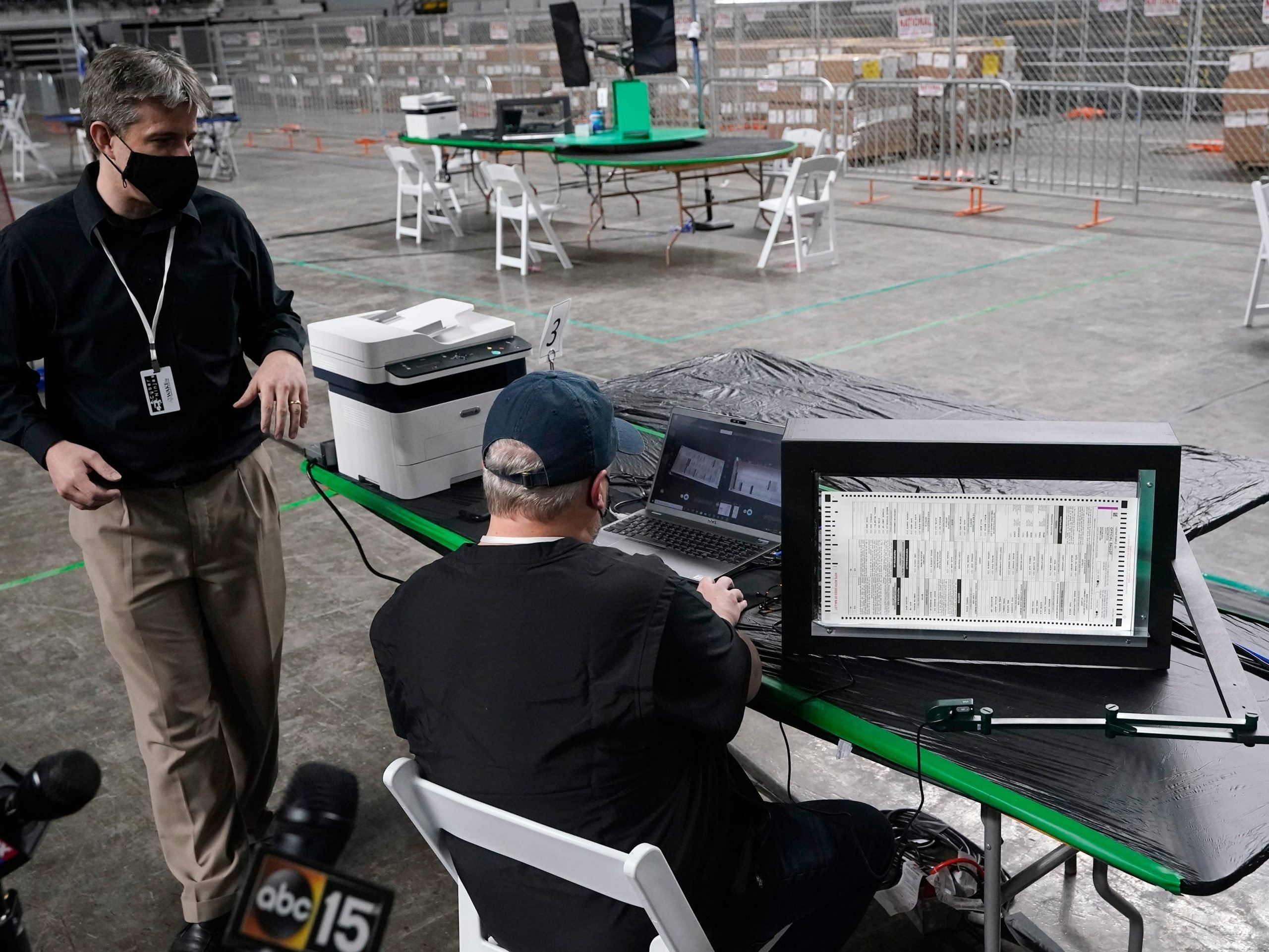 Cyber Ninjas owner Doug Logan, left, a Florida-based consultancy, talks about overseeing a 2020 election ballot audit ordered by the Republican lead Arizona Senate at the Arizona Veterans Memorial Coliseum.