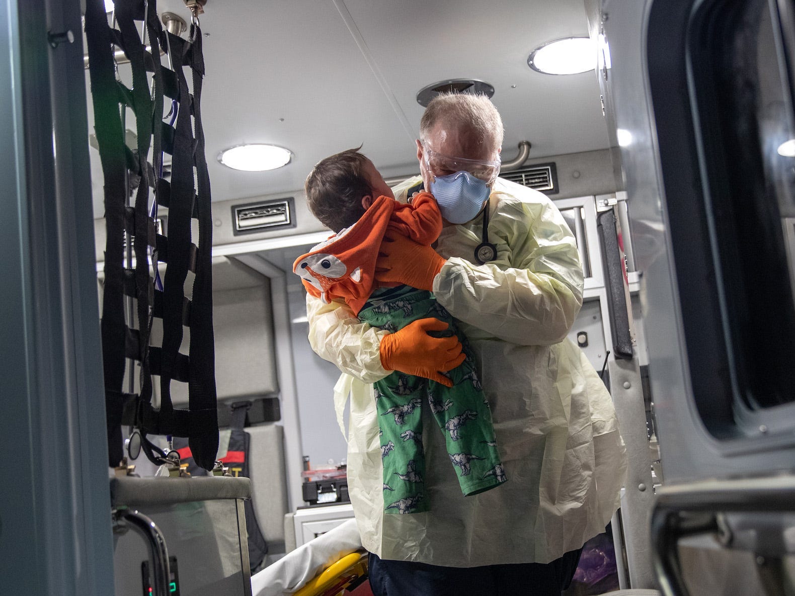 10 month old in medics arms, being carried out of ambulance