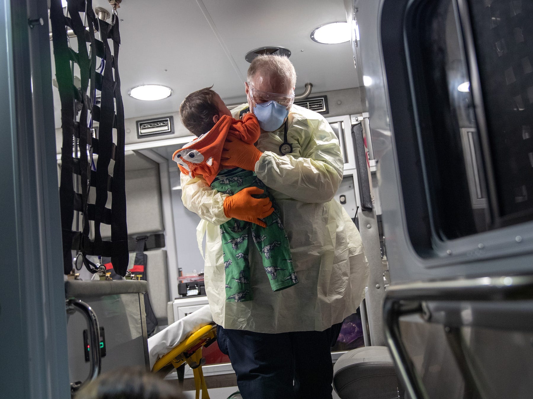 10 month old in medics arms, being carried out of ambulance