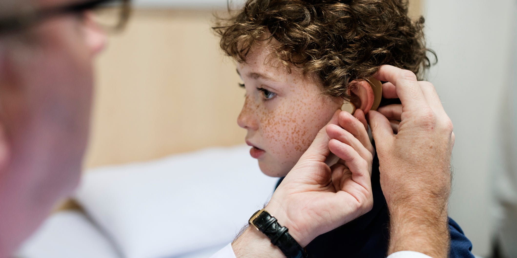 child being fitted for a hearing aid