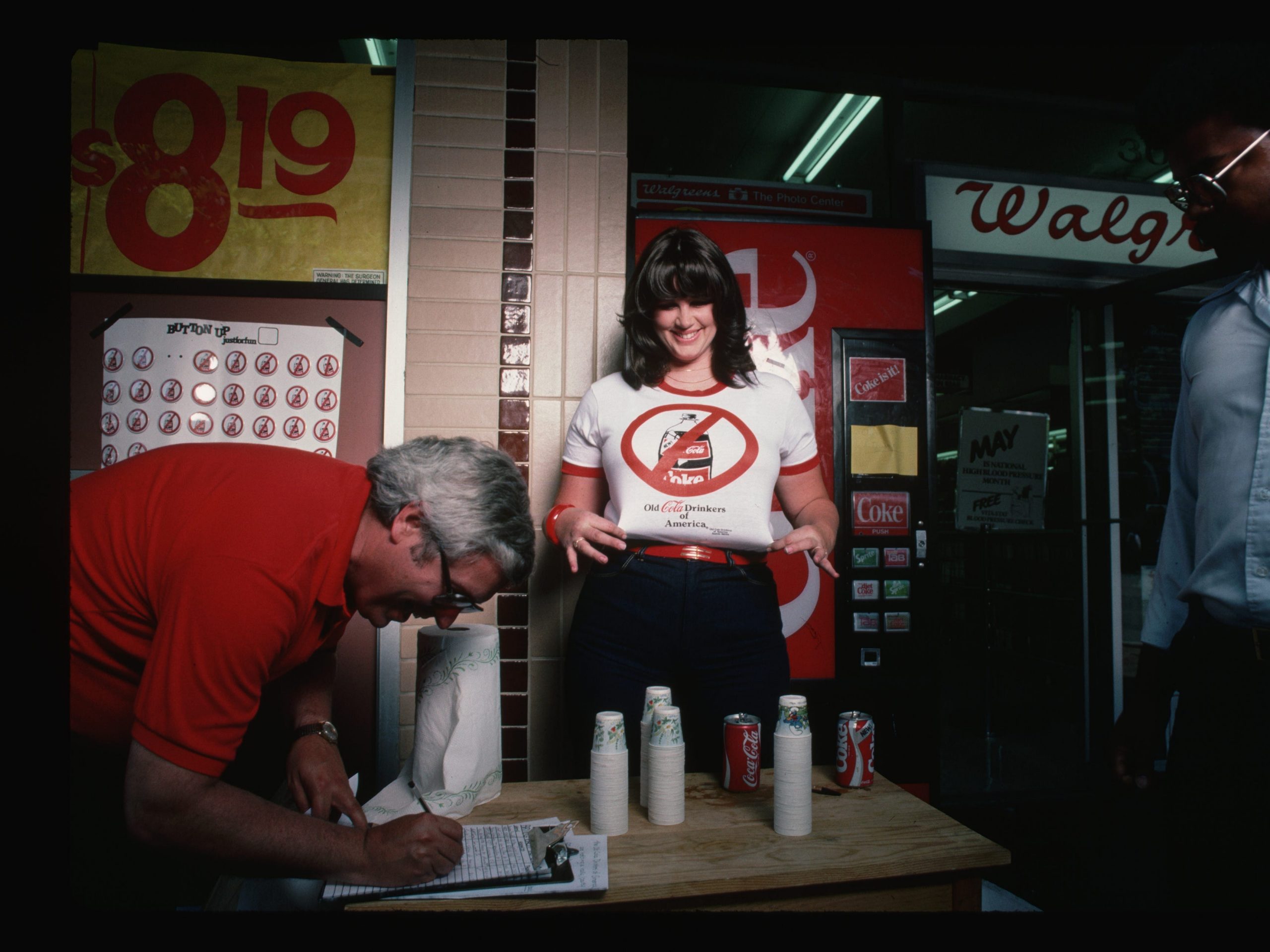 Outside a Walgreens, Karen Wilson gathers signatures on a petition to the Coca-Cola Company expressing dissatisfaction with its "New Coke" formula in 1985.