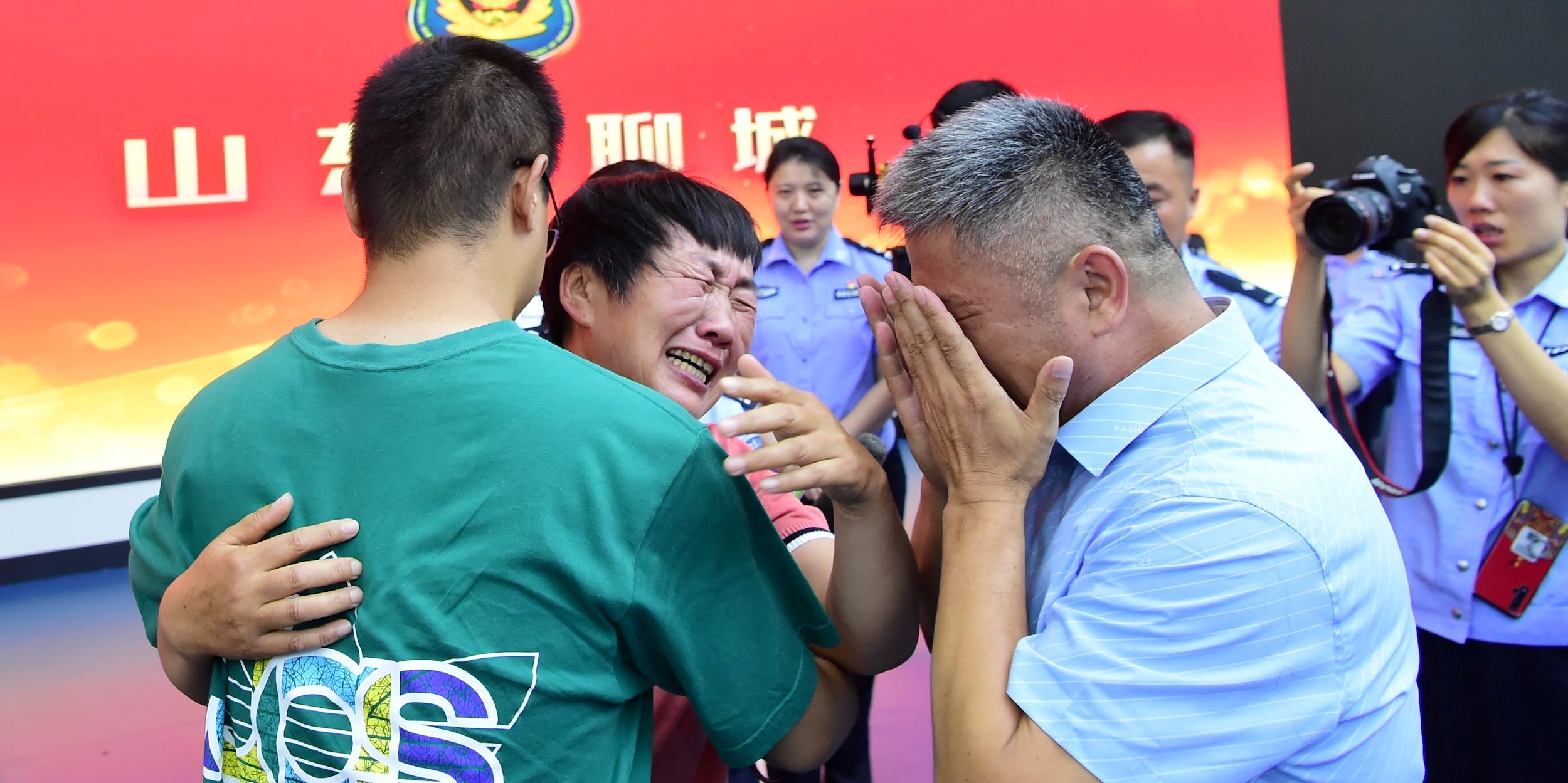 Guo Gangtang, 51, and his wife reunite with their son Guo Xinzhen, who was abducted 24 years ago at the age of 2, at a family reunion arranged by the police, in Liaocheng, Shandong province, China July 11, 2021. Picture taken July 11, 2021.