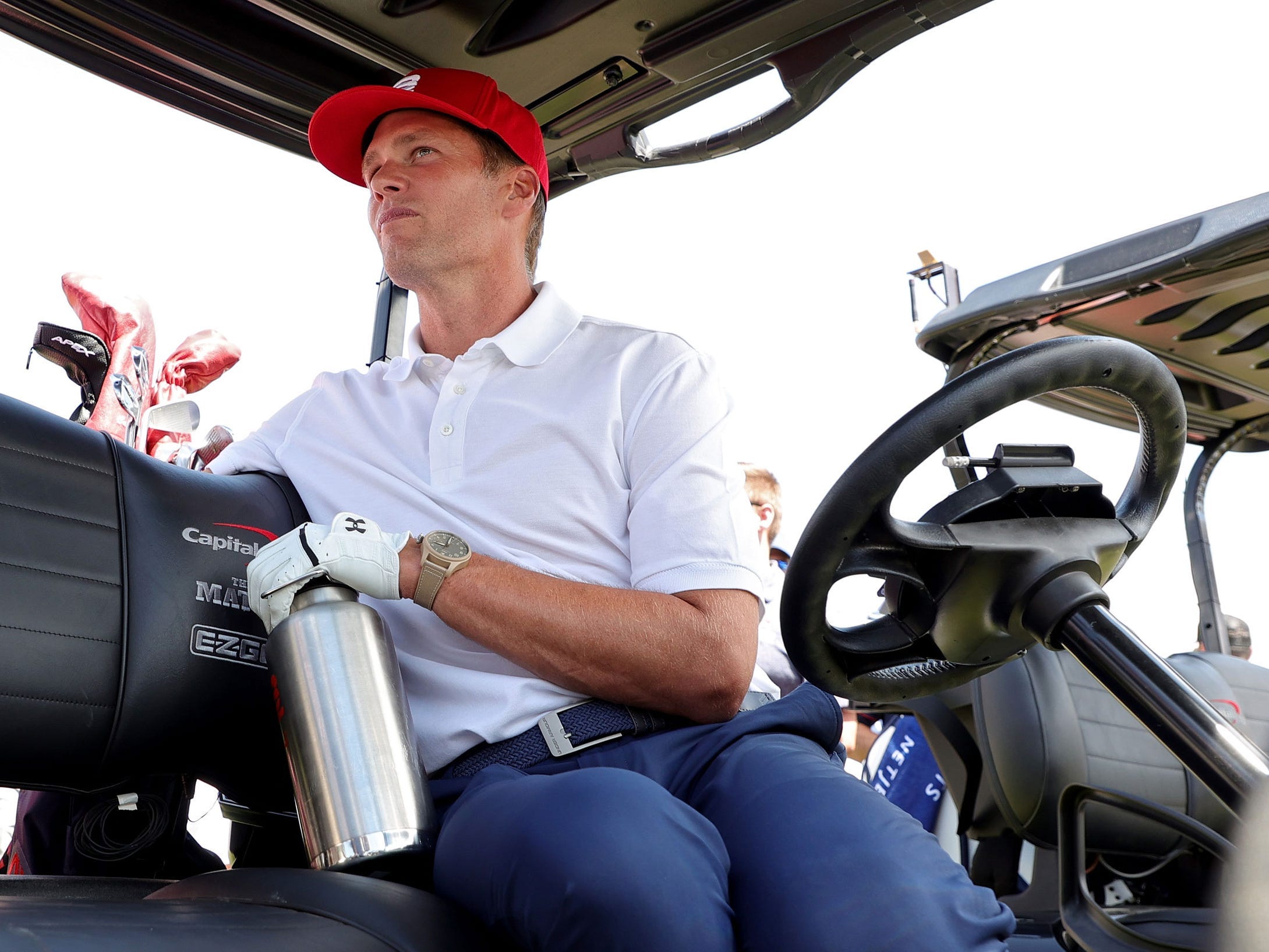 Tom Brady sits in his golf cart at The Match.