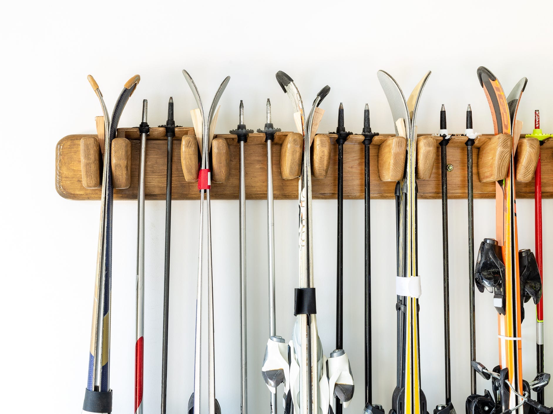 Ski equipment hanging on a wall rack.