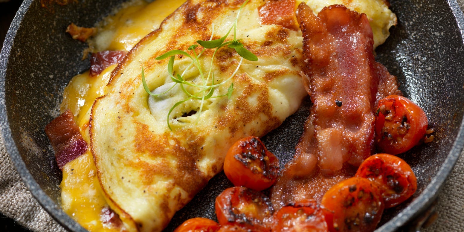 cheesy omelette with bacon and tomatoes for breakfast
