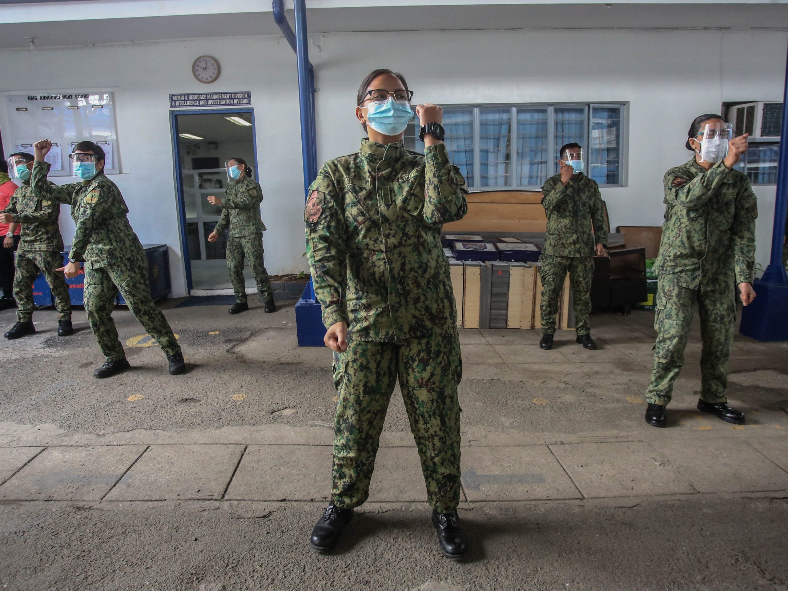 Members of the Philippine National Police conduct morning exercises in their office in Quezon City, January 25, 2021. This is part of a fitness program in the force to combat obesity and weight gain amongst its personnel.