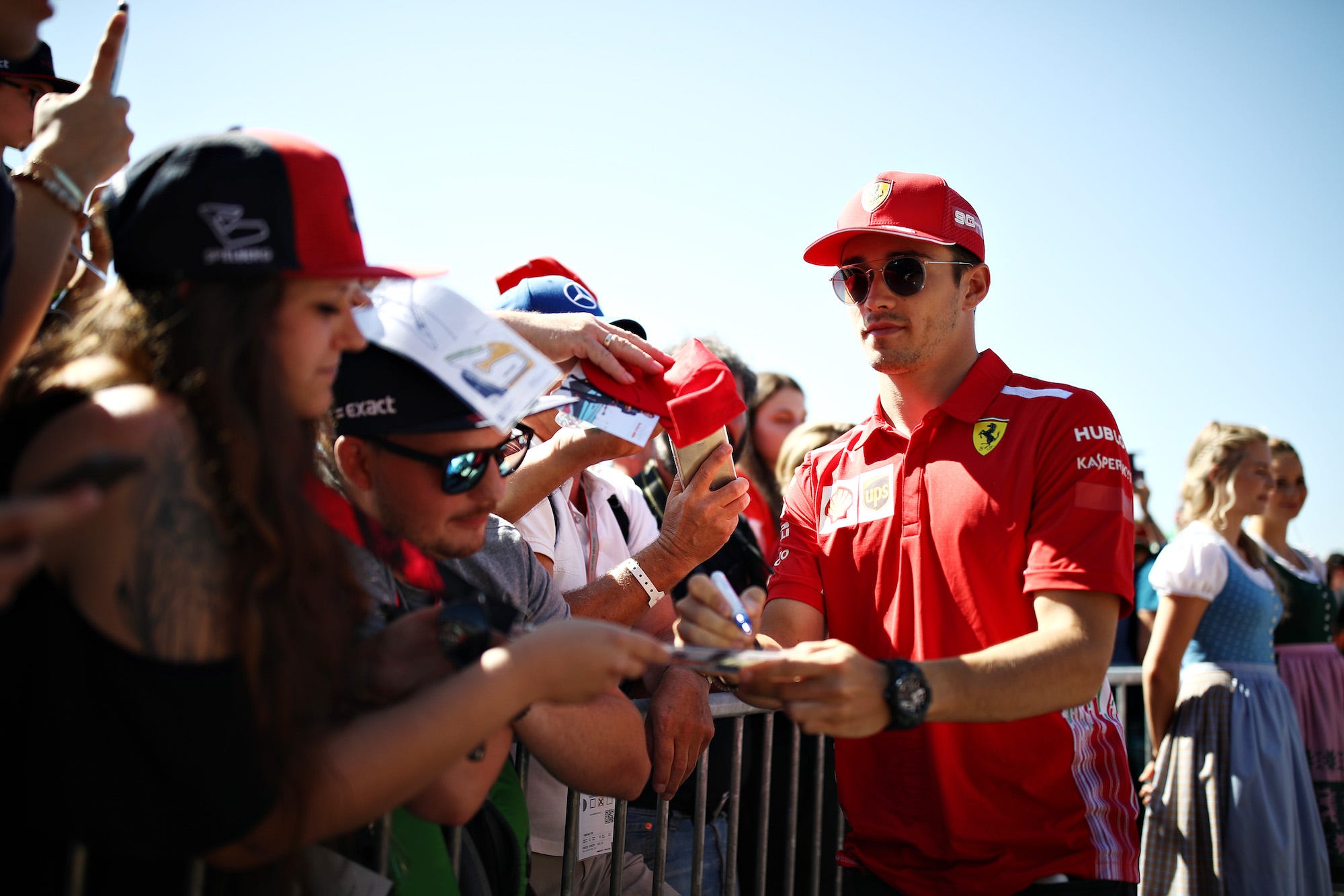 Charles Leclerc of Monaco and Ferrari arrives at the circuit and signs autographs for fans before final practice for the F1 Grand Prix of Austria at Red Bull Ring on June 29, 2019 in Spielberg, Austria