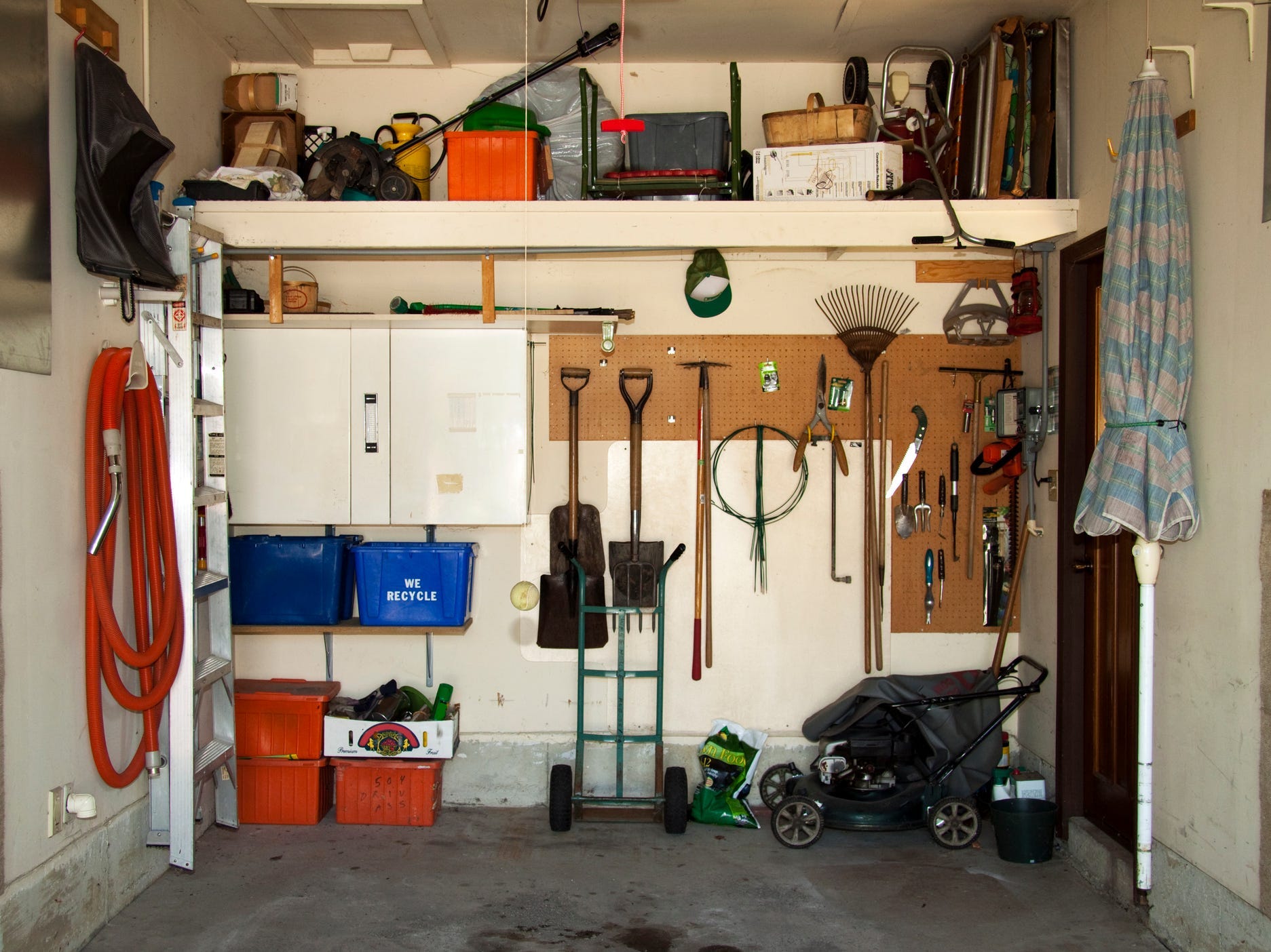 Organized garage interior with items hanging on the walls.