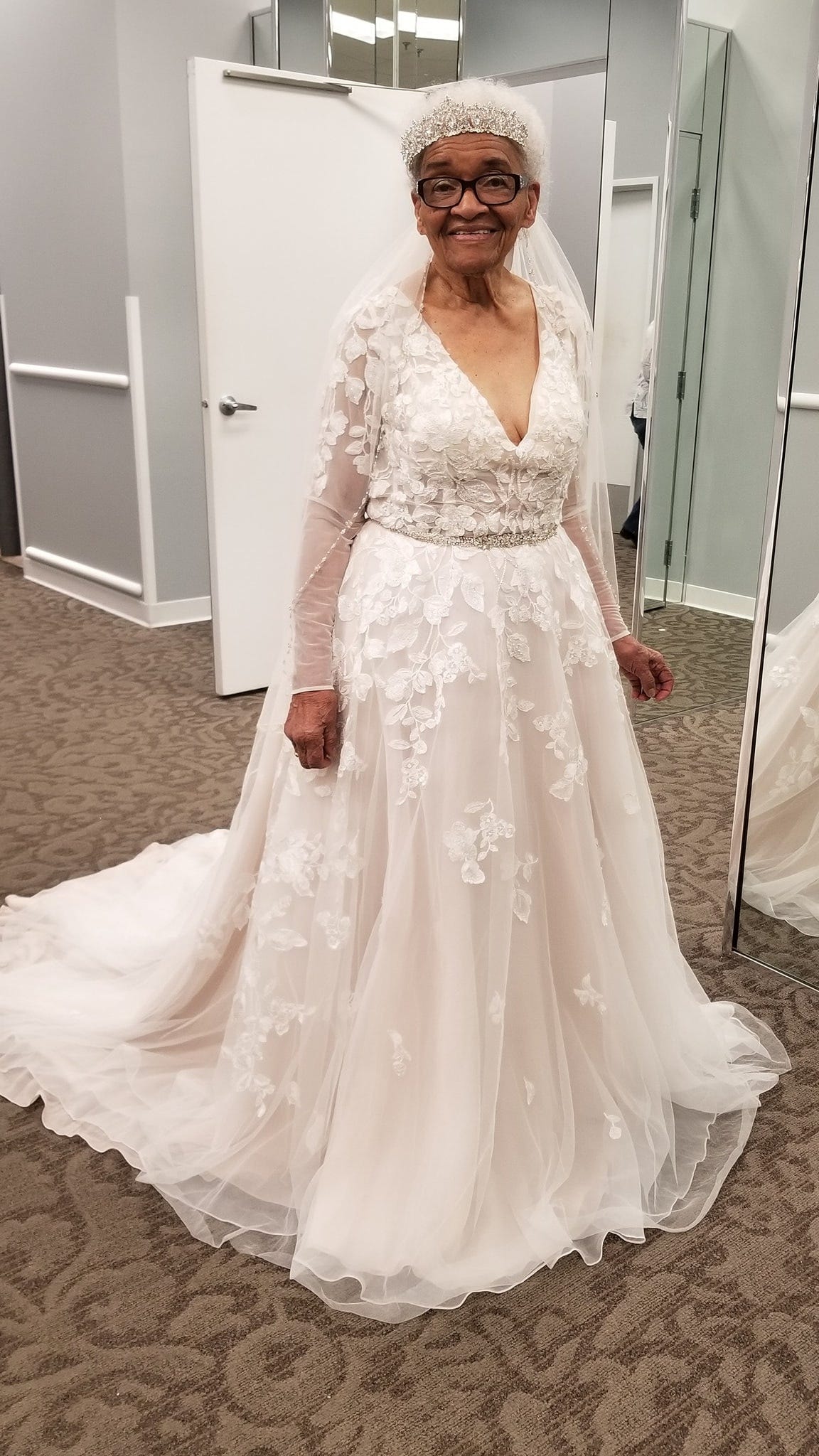 Martha Mae Ophelia Moon Tucker trying on a V neck lace dress at David's Bridal boutique.