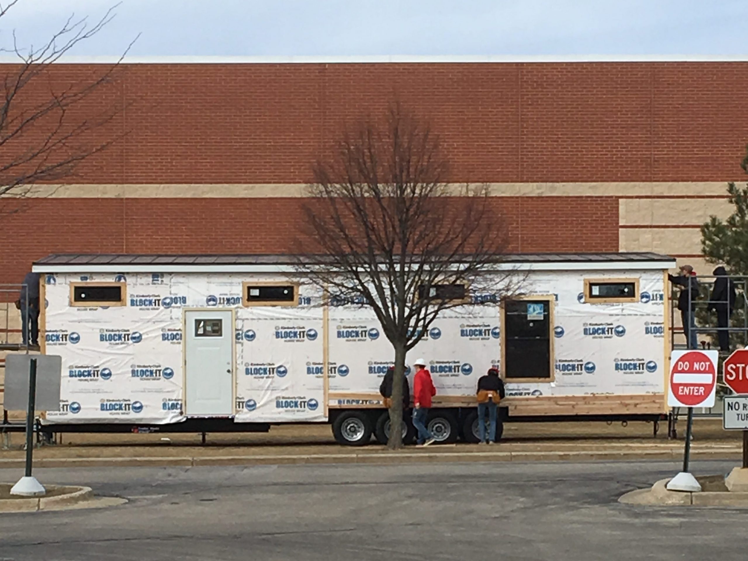 partially built tiny house parked outside of Wisconsin high school